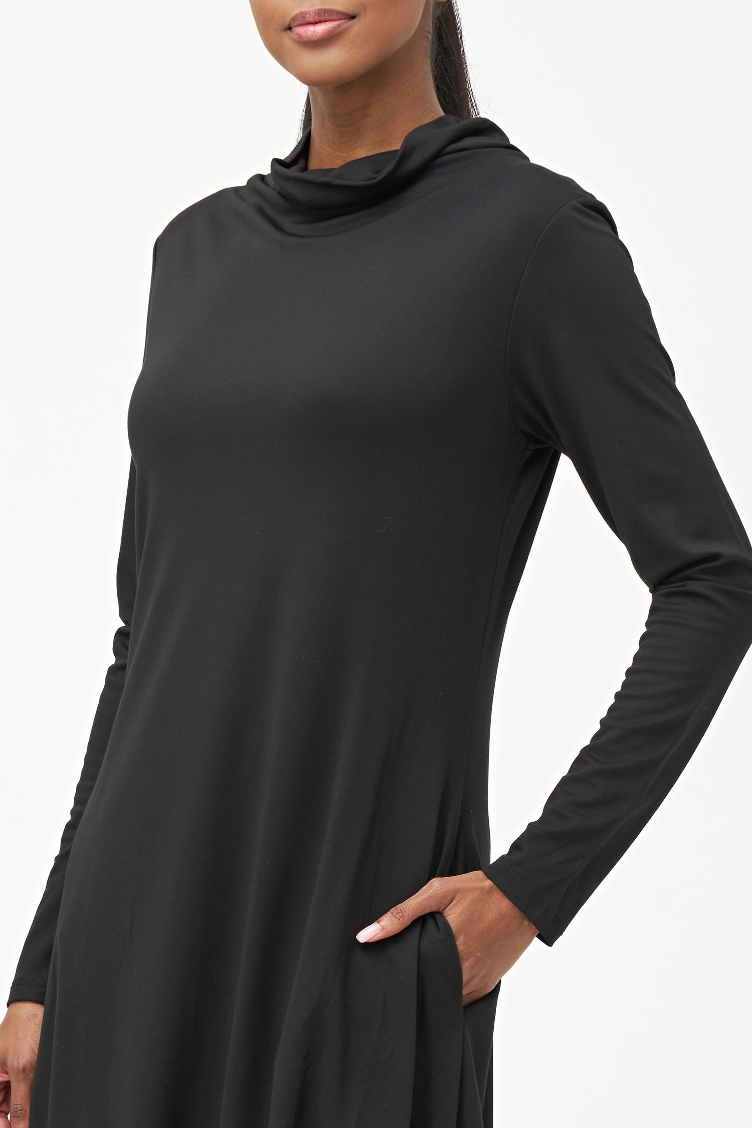 Long sleeve black dress with a soft turtleneck and relaxed A-line silhouette, crafted in stretchy ribbed knit fabric.