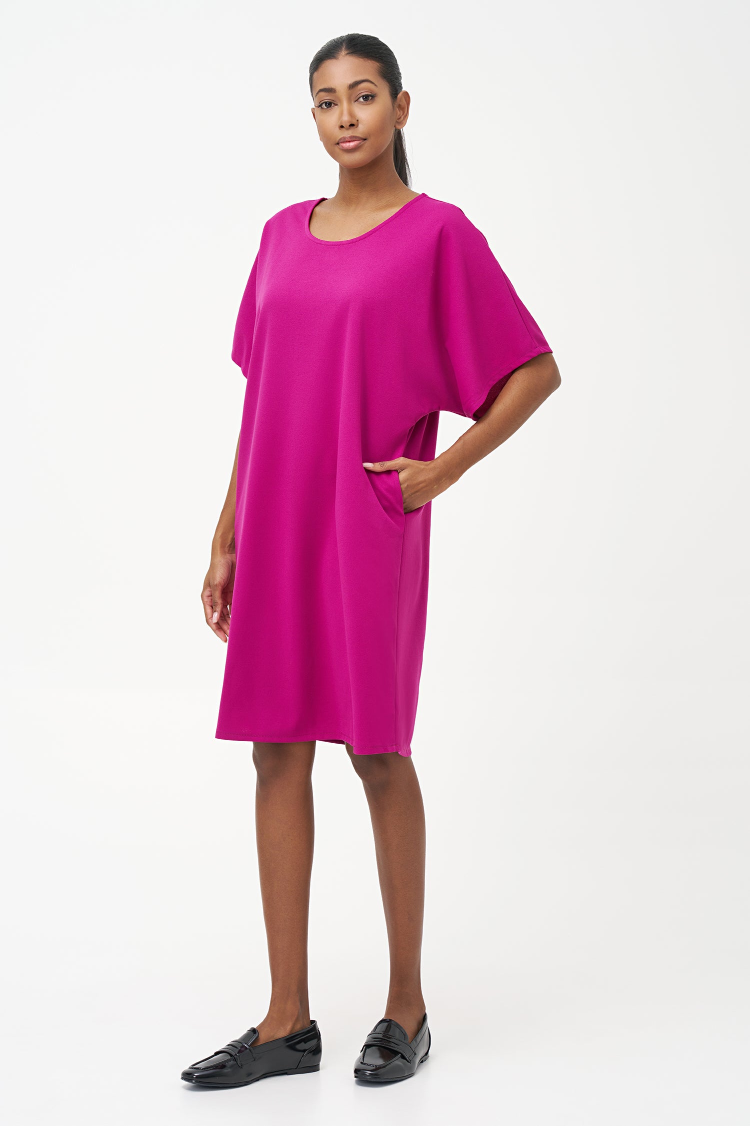 Loose-fit pink knee-length dress with short sleeves and round neckline in soft stretch polyester blend.