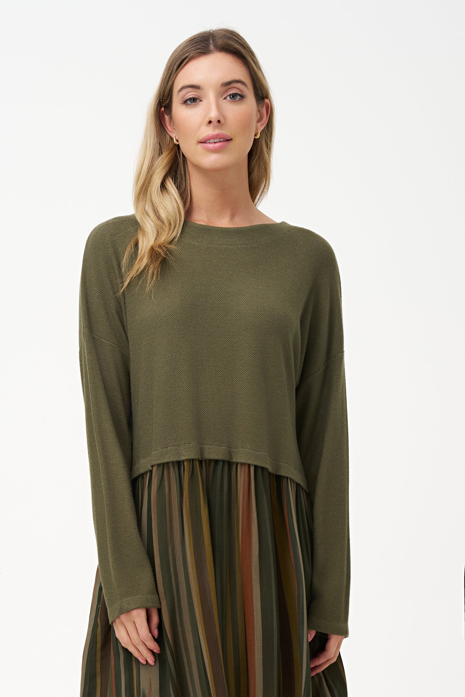 Two-tone long sleeve dress with solid olive knit top and striped flared skirt in earthy tones.