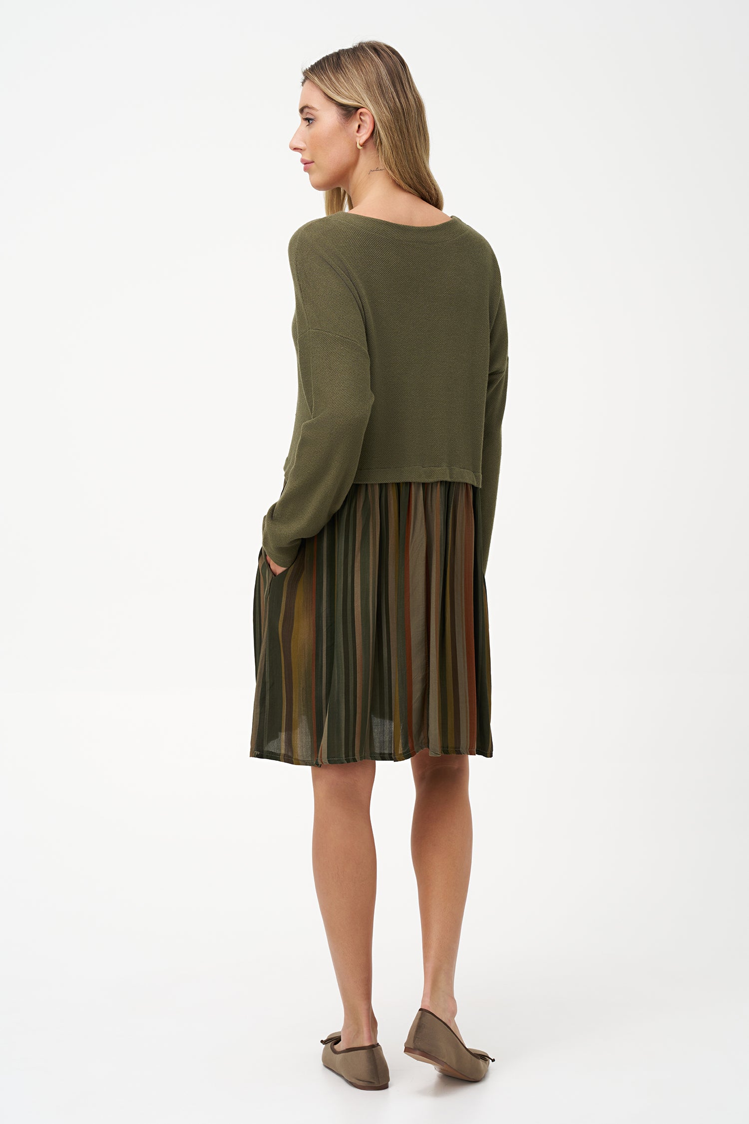 Two-tone long sleeve dress with solid olive knit top and striped flared skirt in earthy tones.