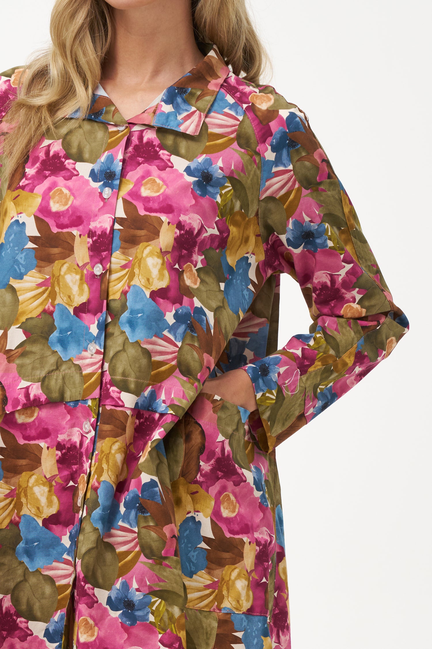 Long-sleeve button-front shirt dress with pink floral bouquet print and pointed collar.