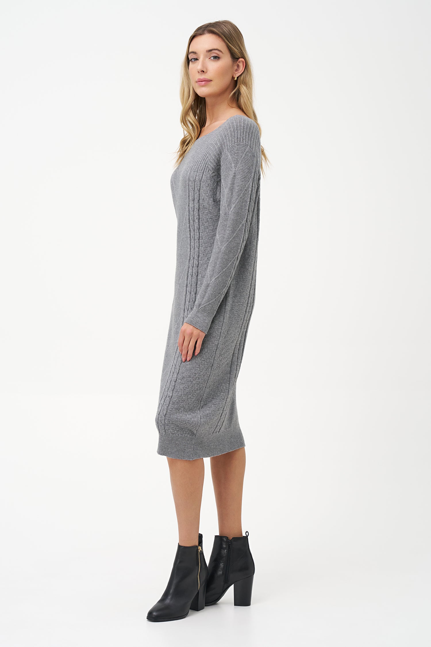Grey cable knit sweater dress with long sleeves and ribbed hemline.