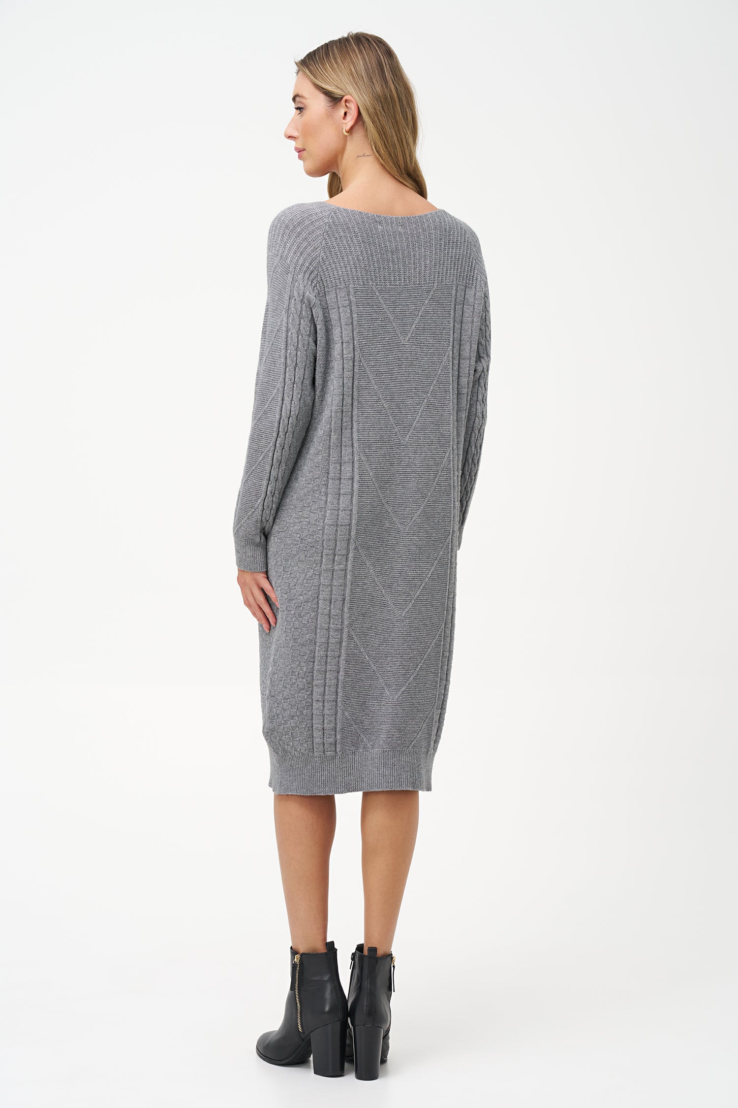 Grey cable knit sweater dress with long sleeves and ribbed hemline.