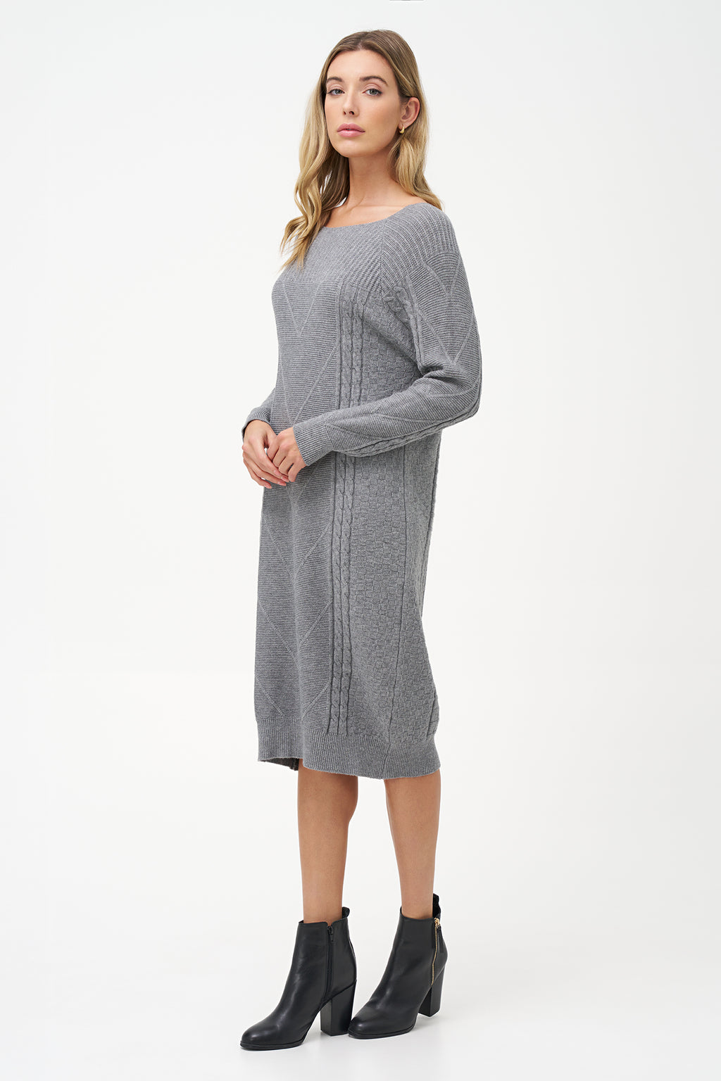 Grey cable knit sweater dress with long sleeves and ribbed hemline.