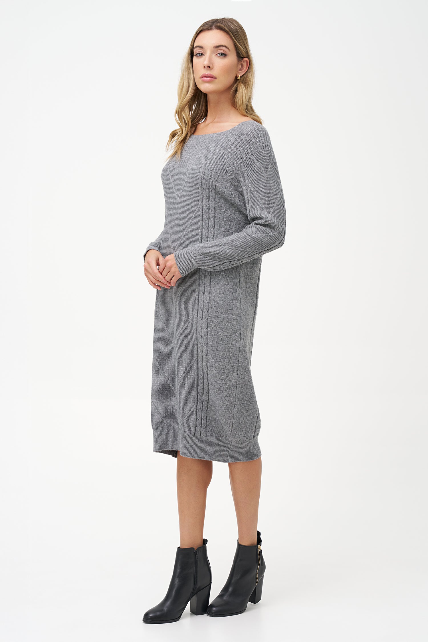 Grey cable knit sweater dress with long sleeves and ribbed hemline.