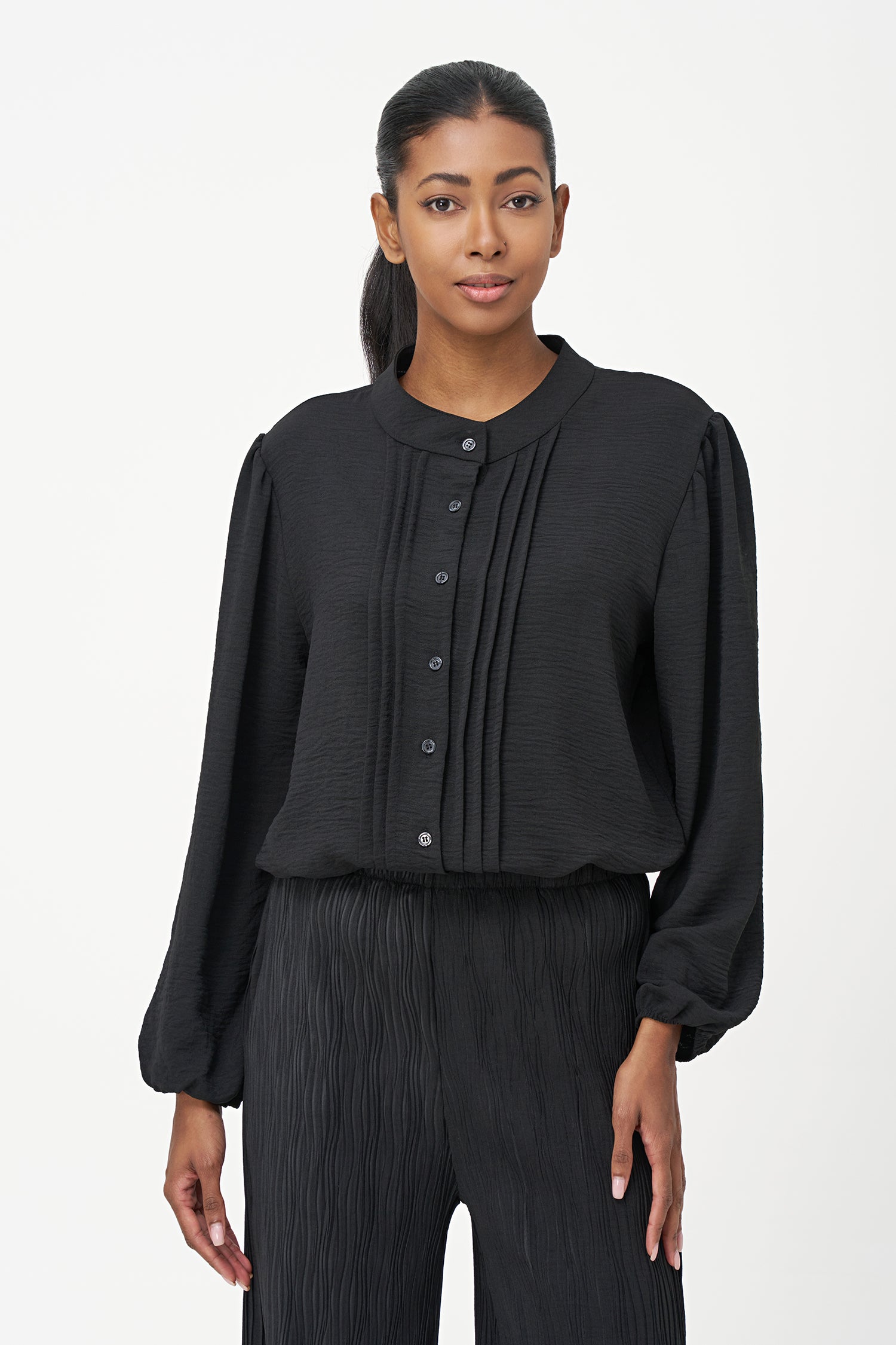 Black long-sleeve blouse with pleated front detail and button-up closure