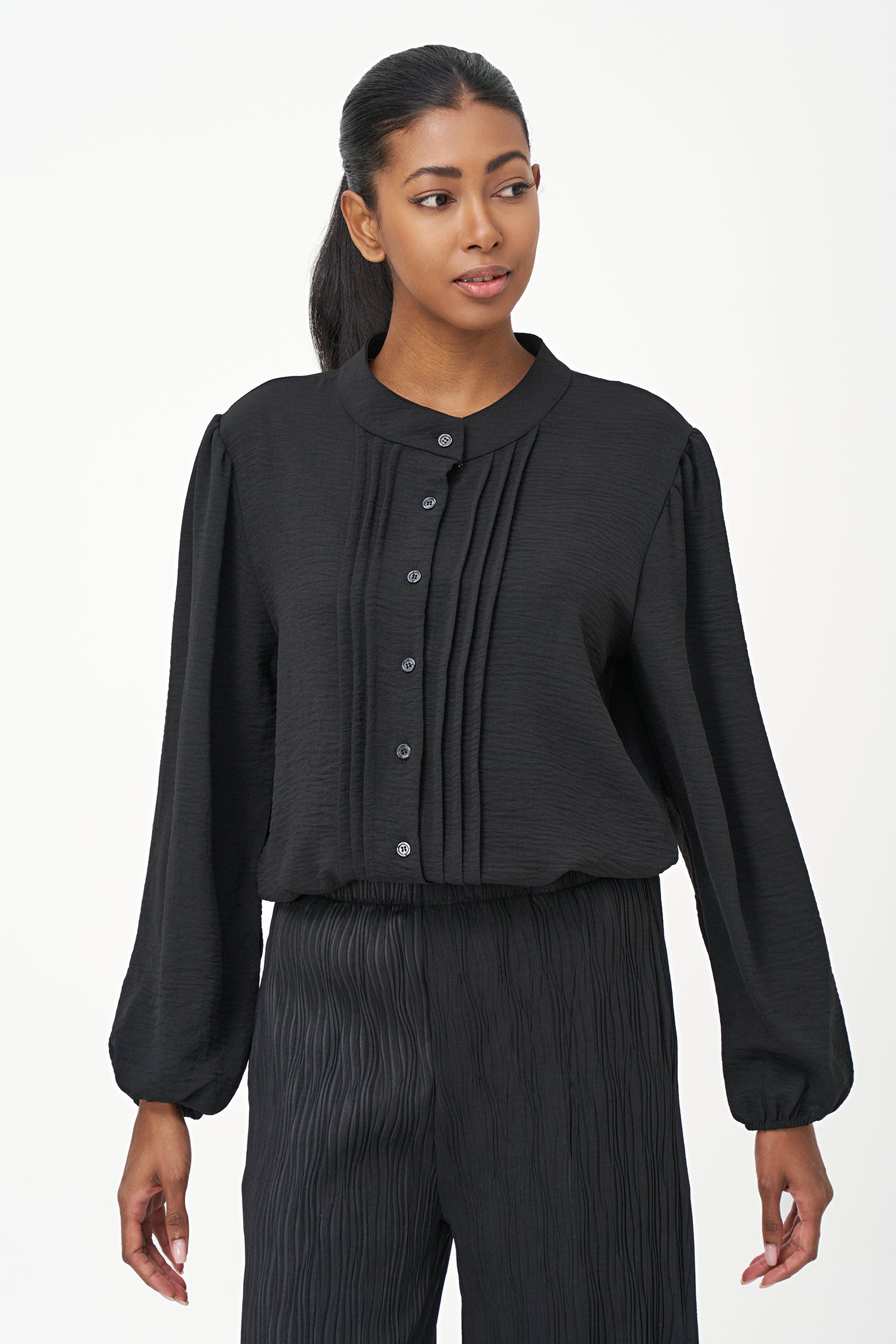 Black long-sleeve blouse with pleated front detail and button-up closure