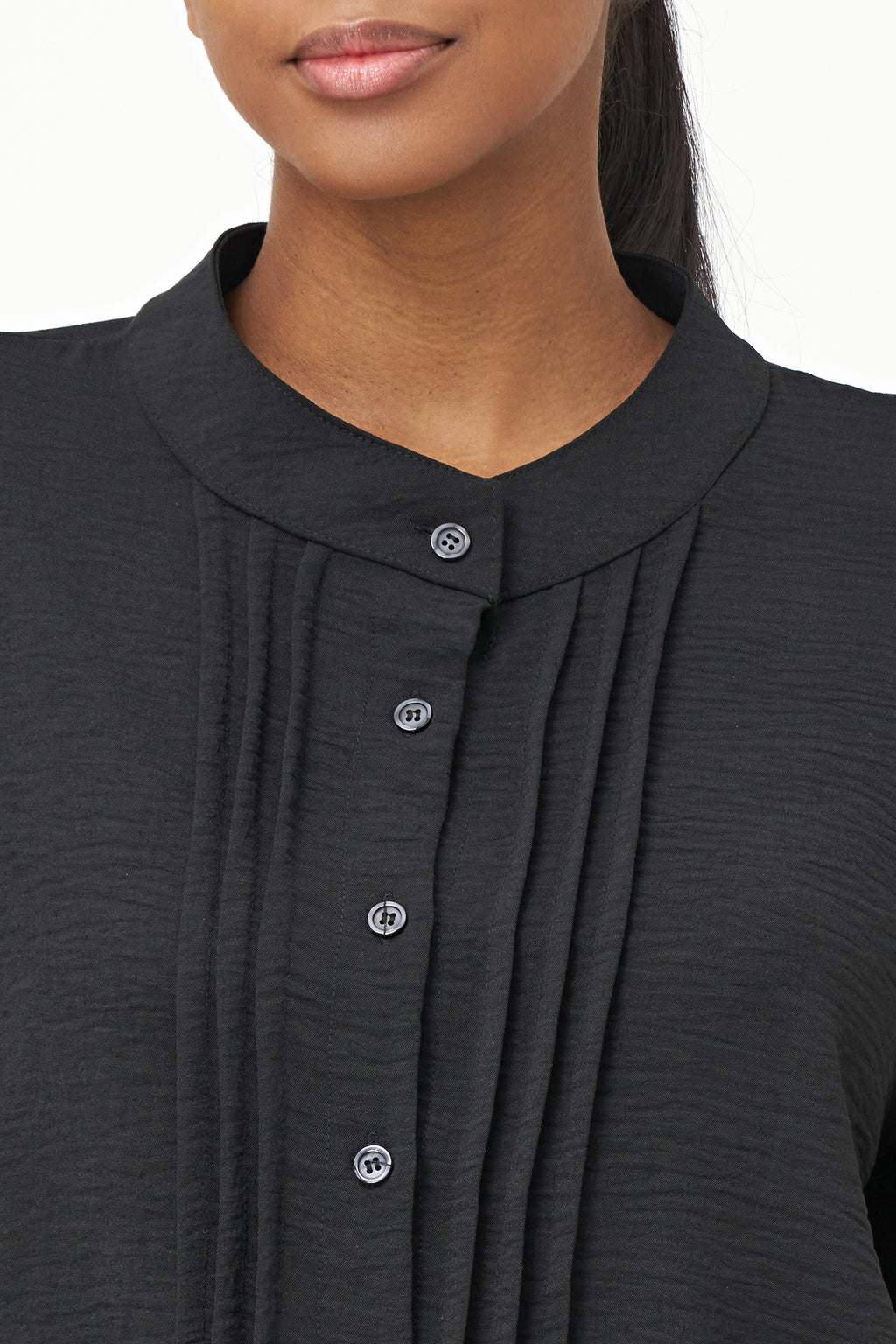 Black long-sleeve blouse with pleated front detail and button-up closure