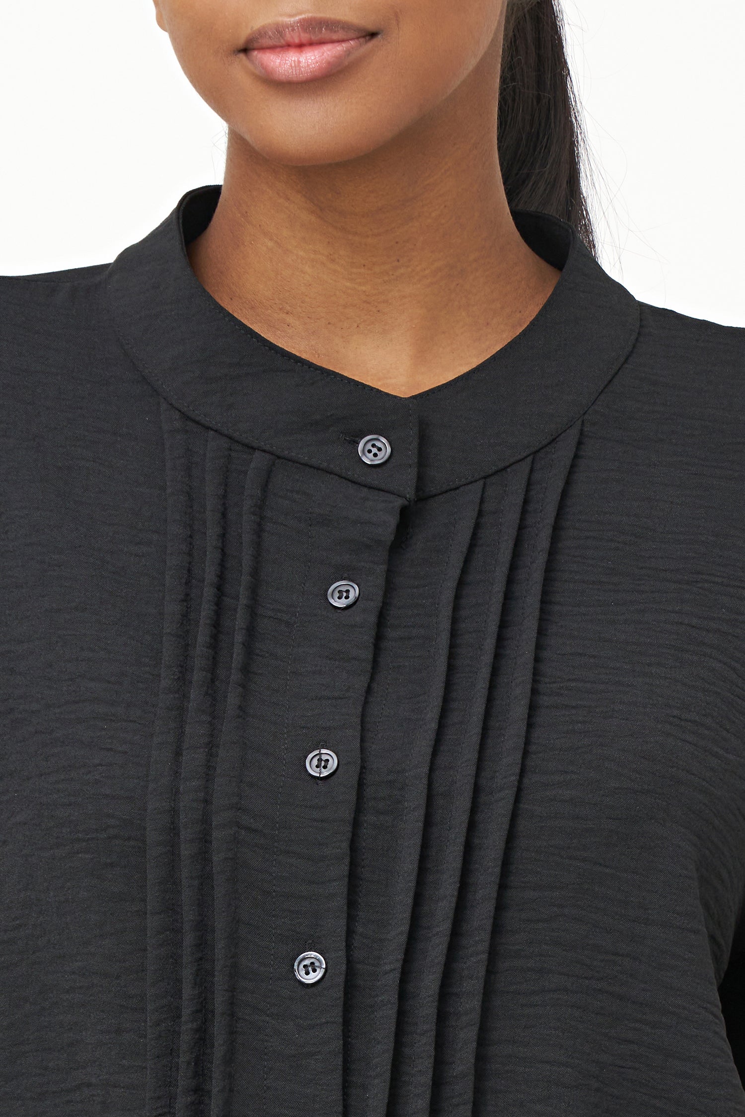 Black long-sleeve blouse with pleated front detail and button-up closure