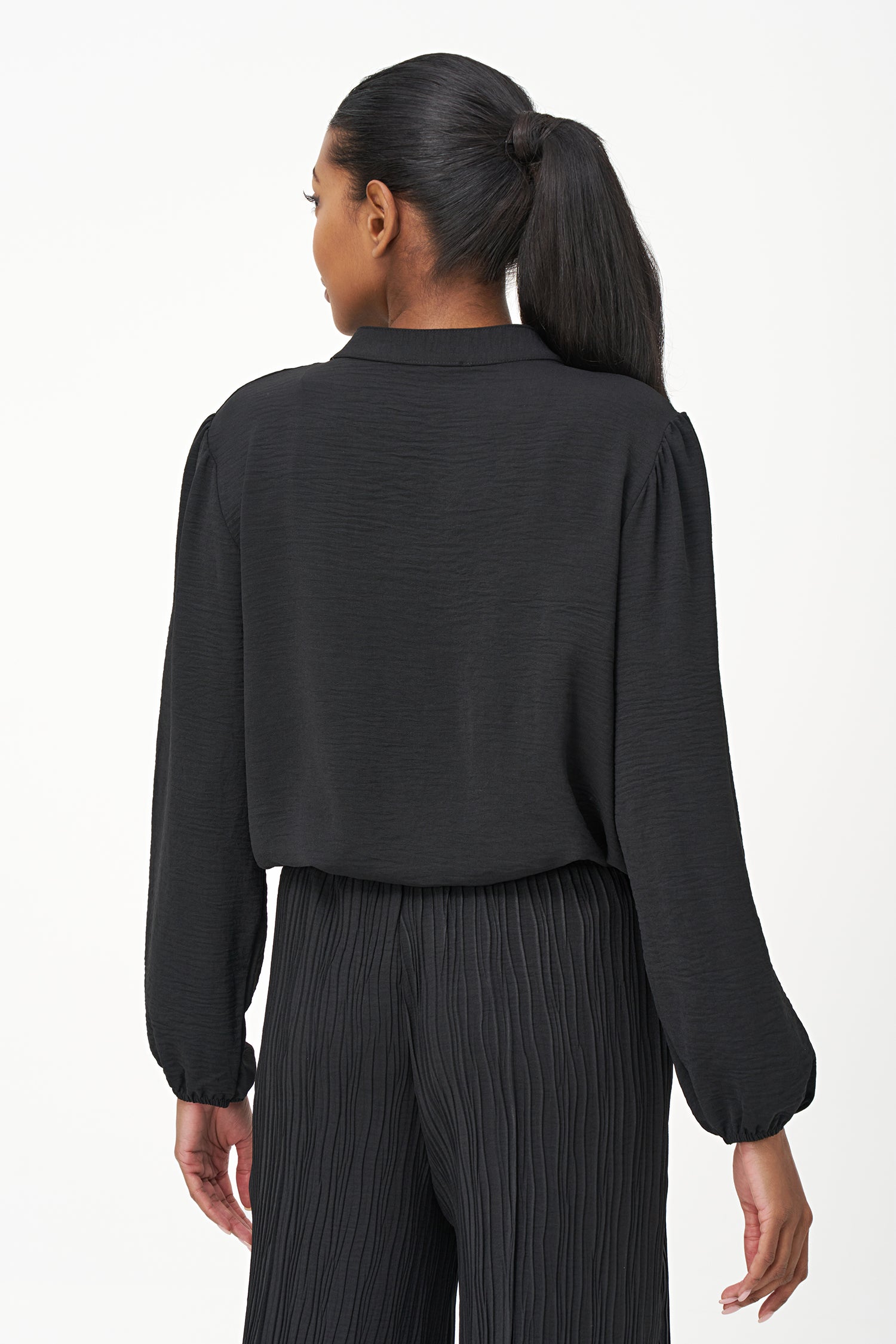 Black long-sleeve blouse with pleated front detail and button-up closure