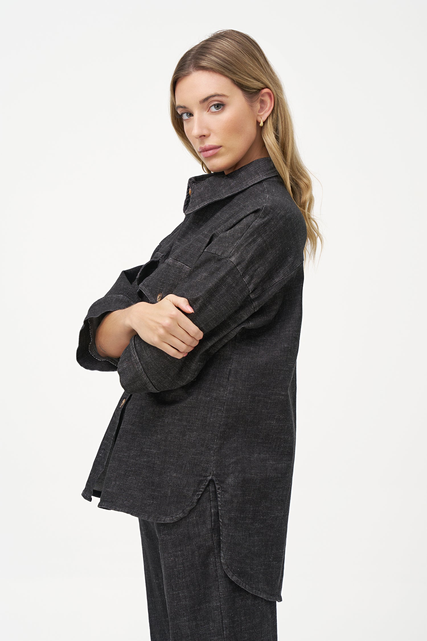 Black denim shirt with wooden buttons, front flap pockets, and 3/4 sleeves