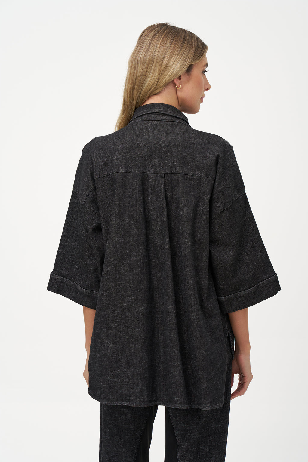 Black denim shirt with wooden buttons, front flap pockets, and 3/4 sleeves