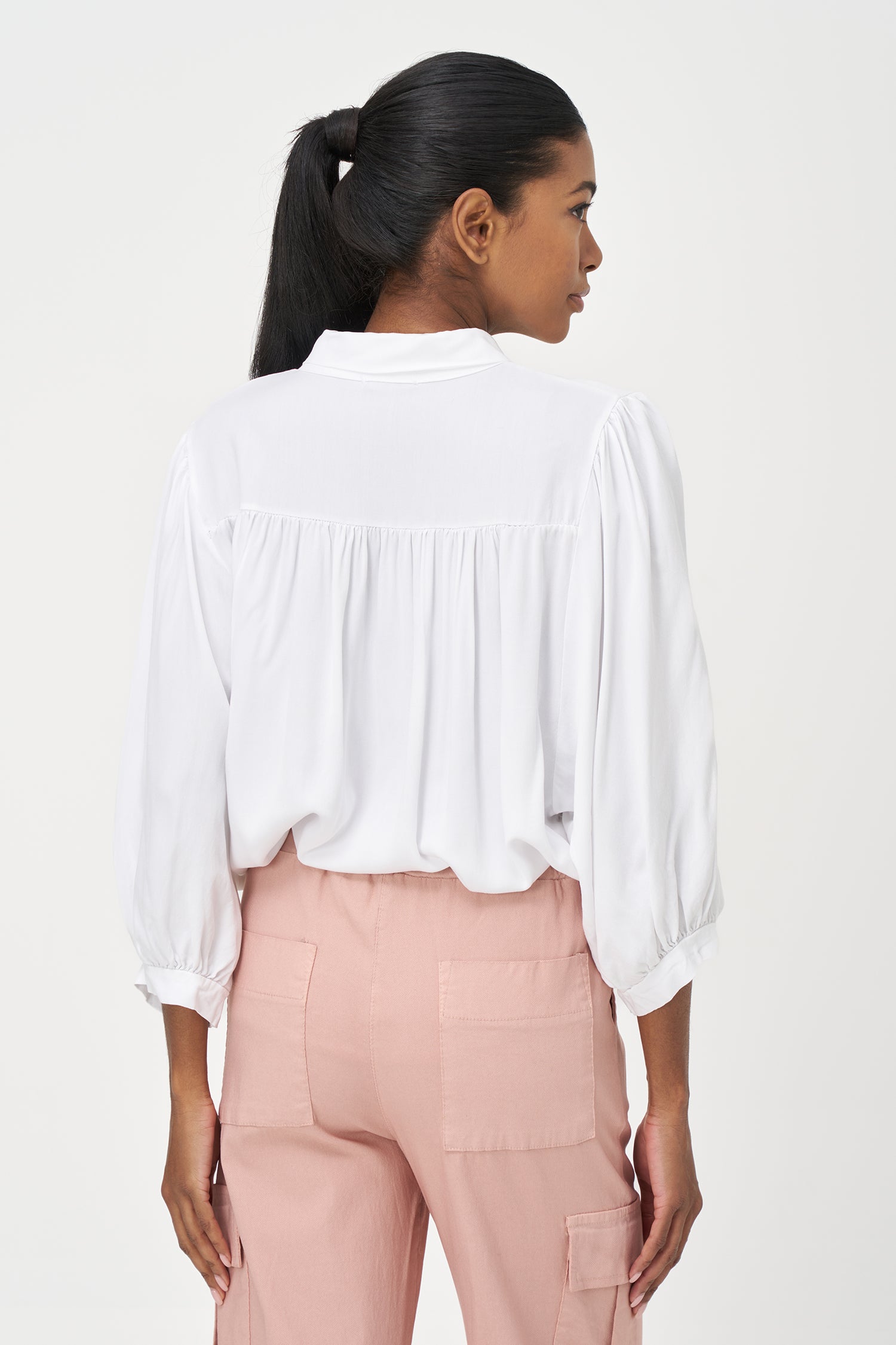 White button-up blouse with relaxed fit, long sleeves, and soft drape