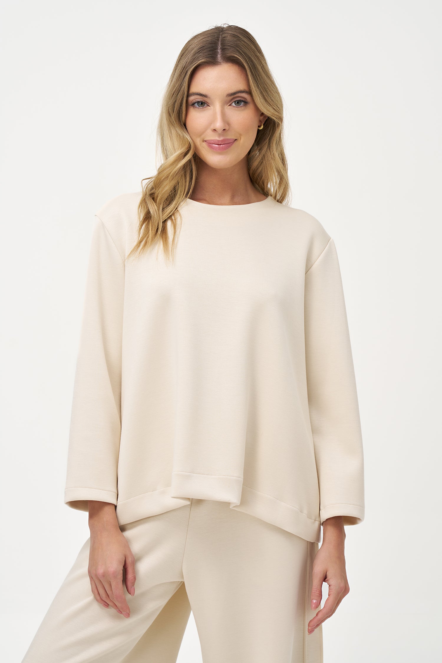 White long sleeve blouse with round neckline and back button closure