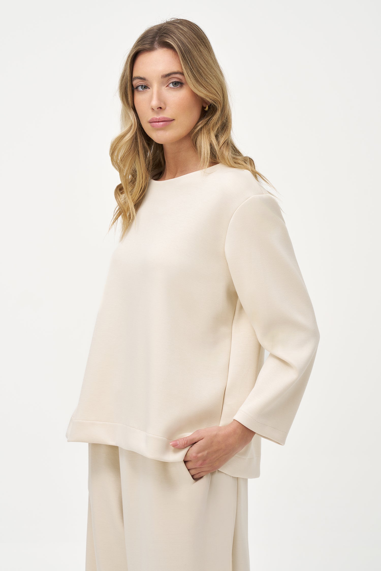 White long sleeve blouse with round neckline and back button closure