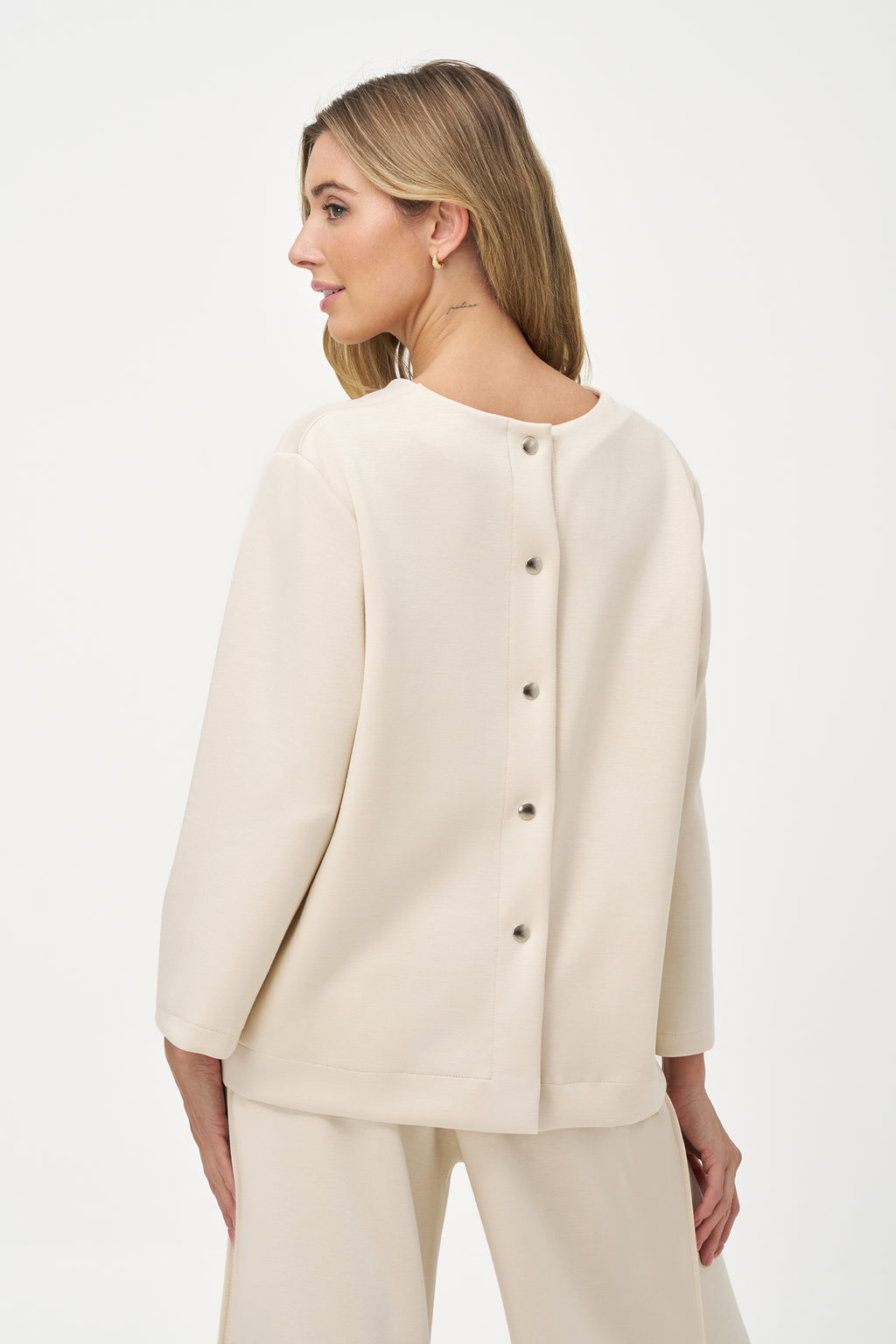 White long sleeve blouse with round neckline and back button closure
