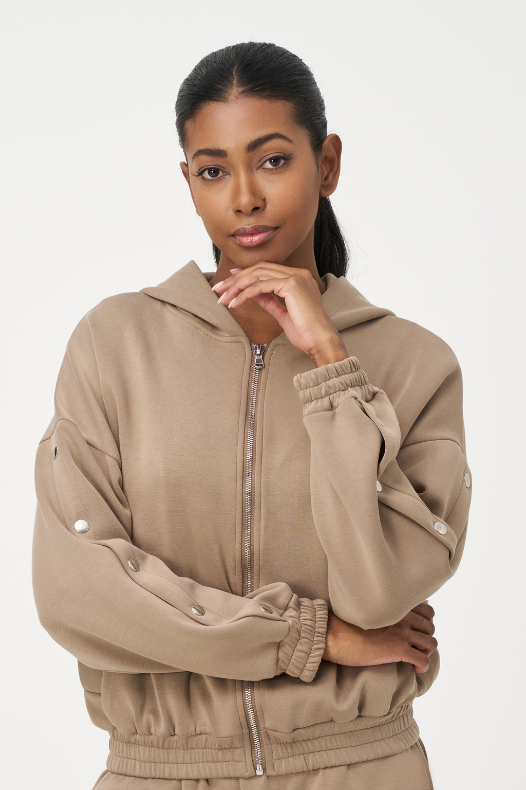 Beige zip-up hoodie with snap button sleeves and elastic cuffs and hem