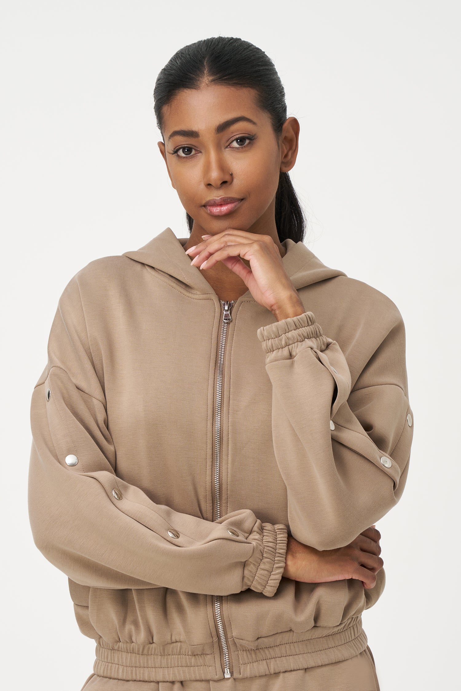 Beige zip-up hoodie with snap button sleeves and elastic cuffs and hem