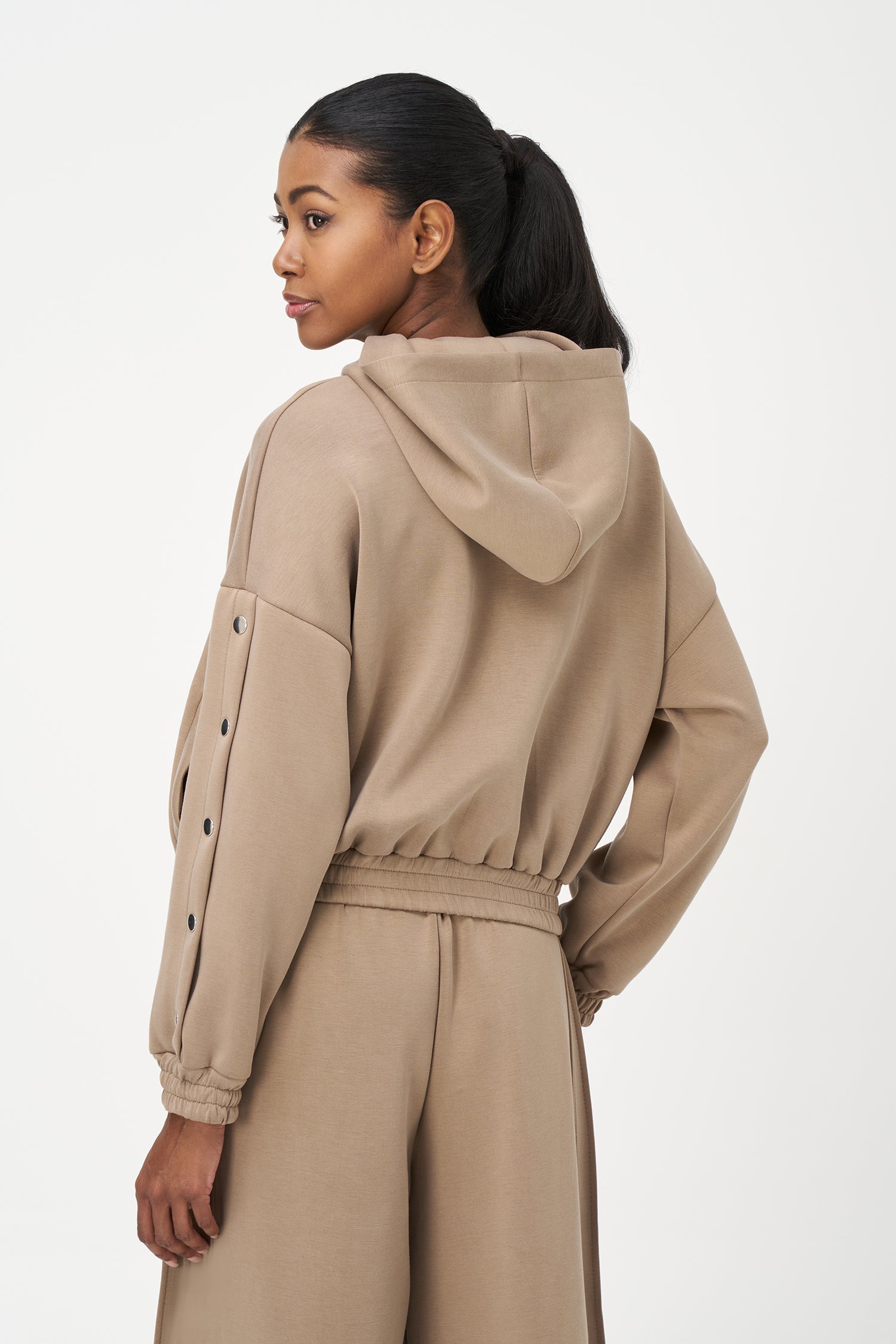 Beige zip-up hoodie with snap button sleeves and elastic cuffs and hem