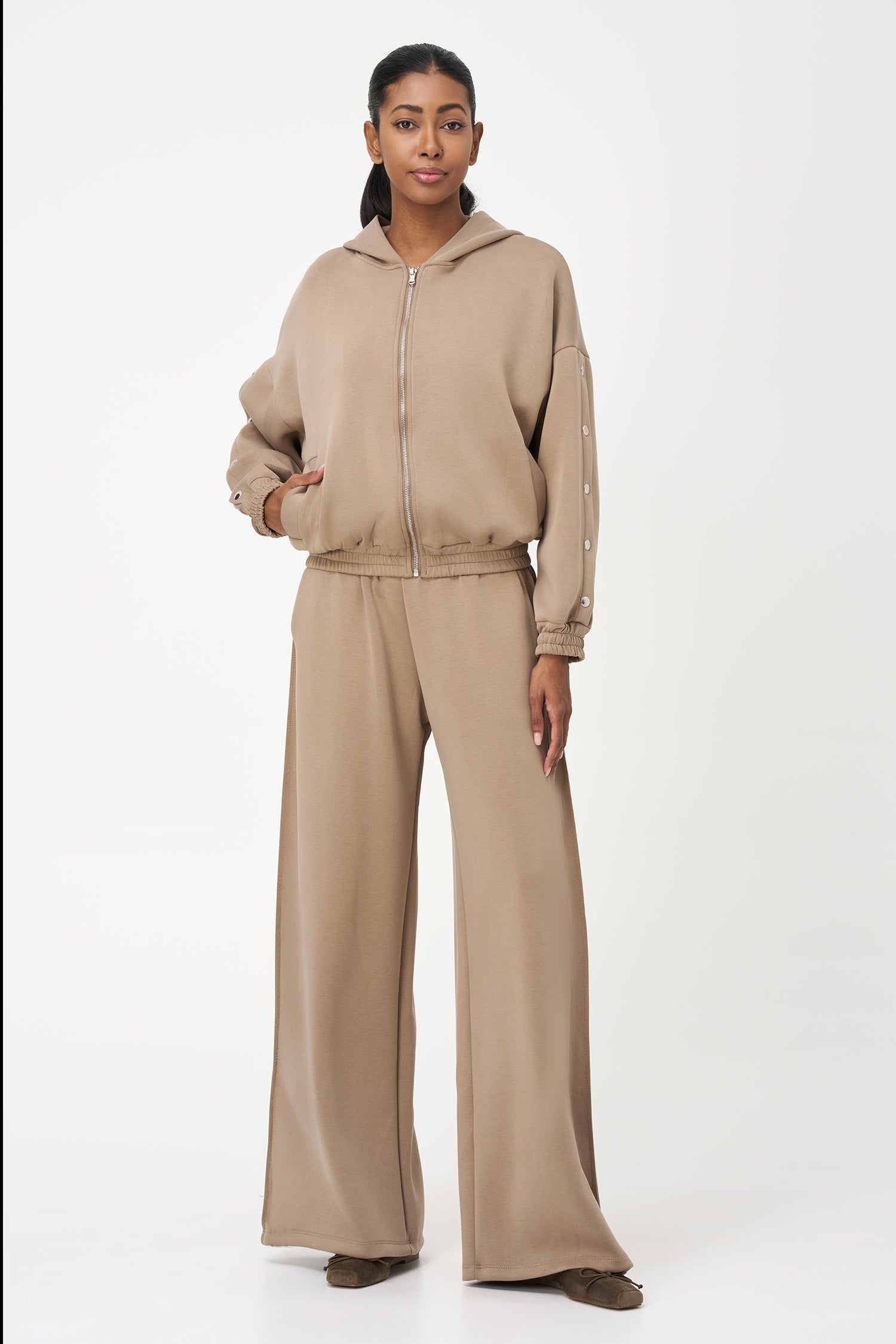 Beige zip-up hoodie with snap button sleeves and elastic cuffs and hem