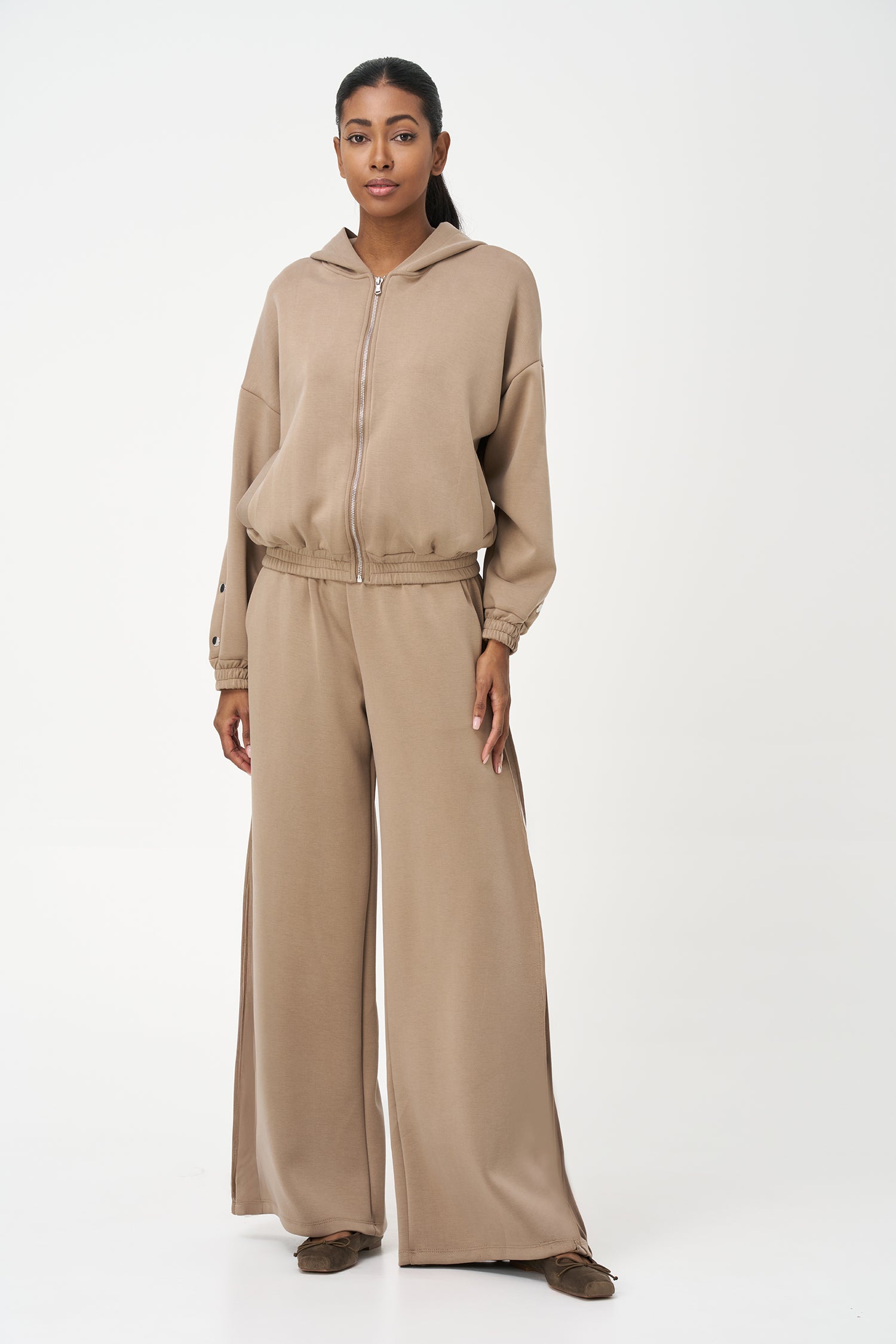 Beige zip-up hoodie with snap button sleeves and elastic cuffs and hem