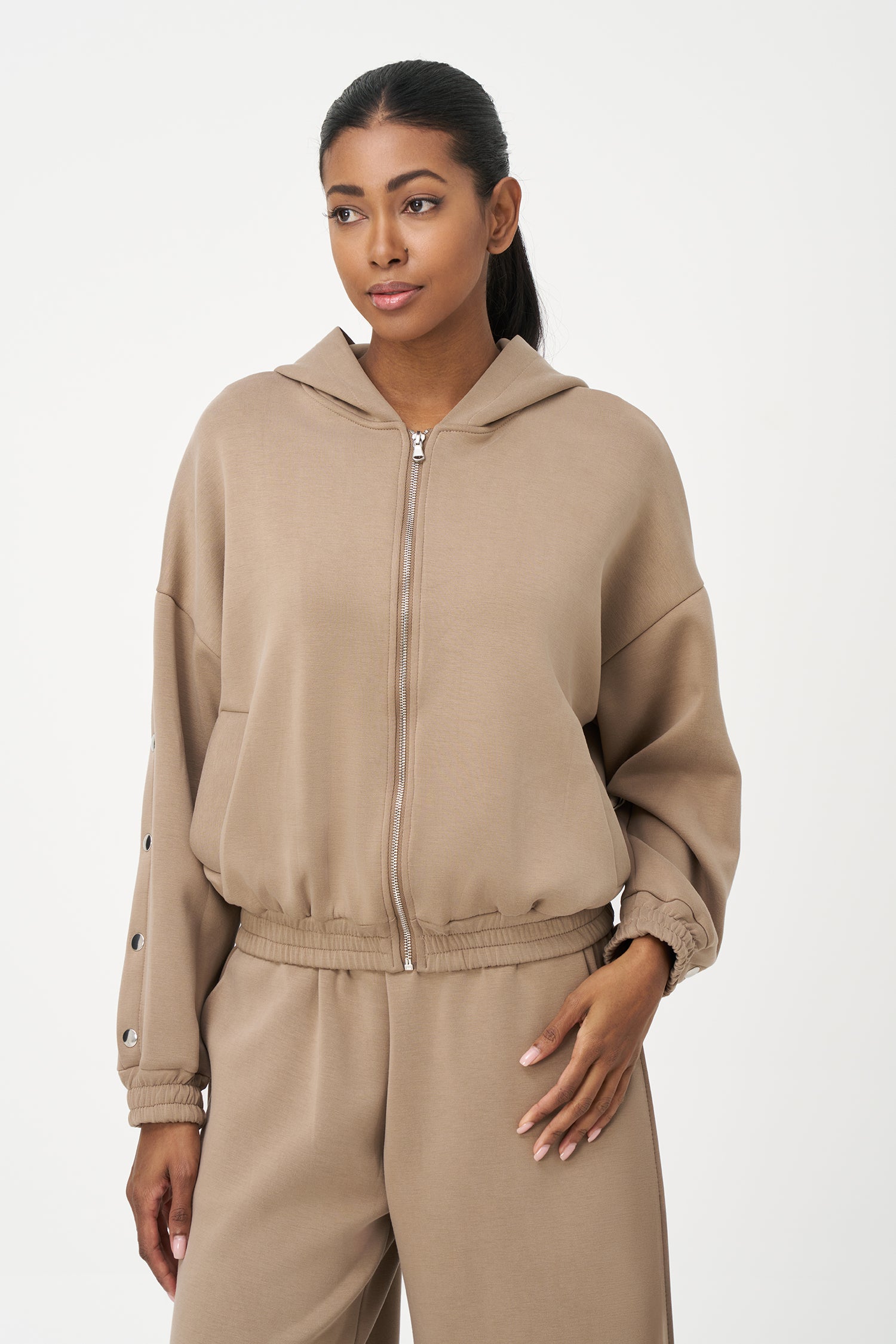 Beige zip-up hoodie with snap button sleeves and elastic cuffs and hem