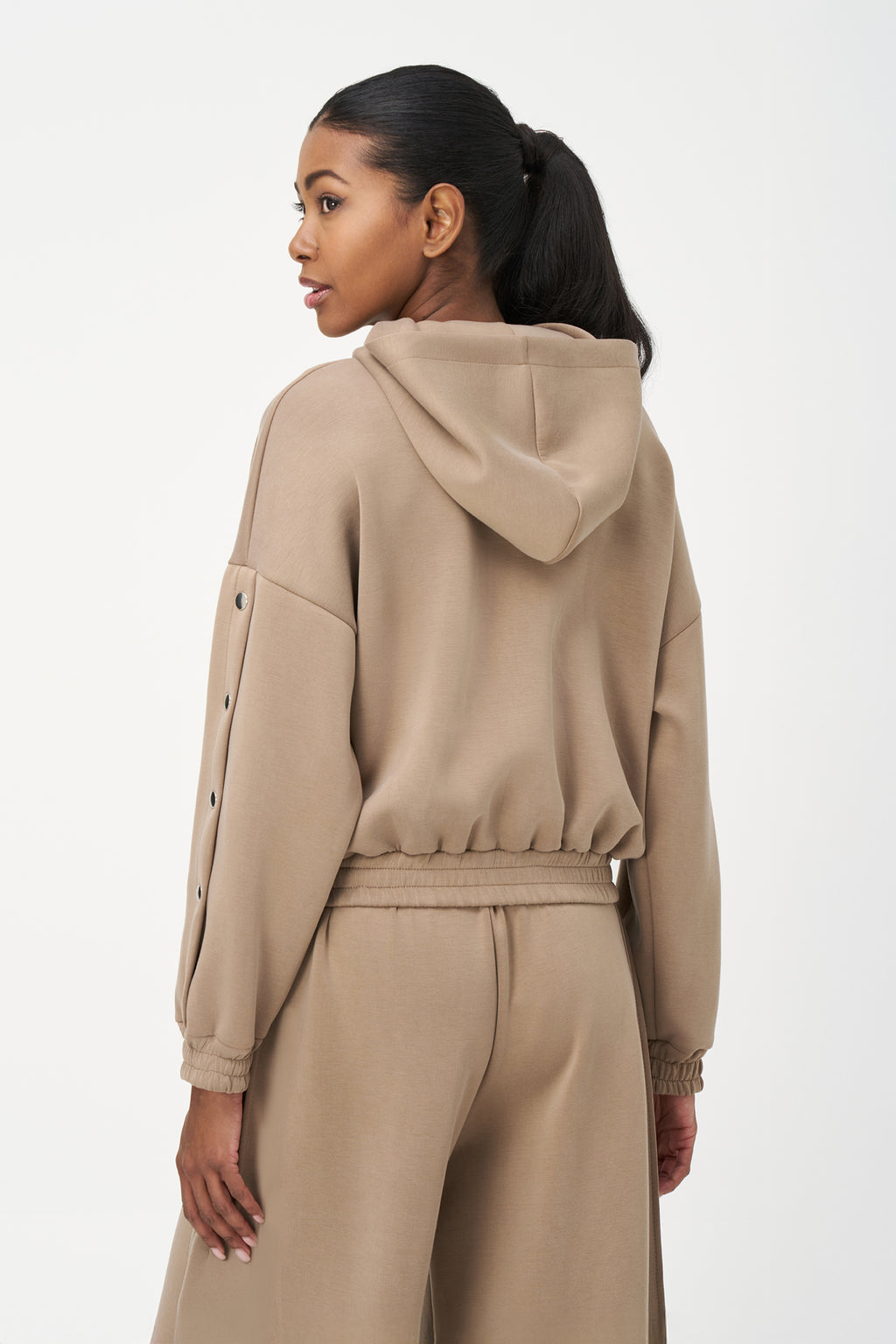 Beige zip-up hoodie with snap button sleeves and elastic cuffs and hem