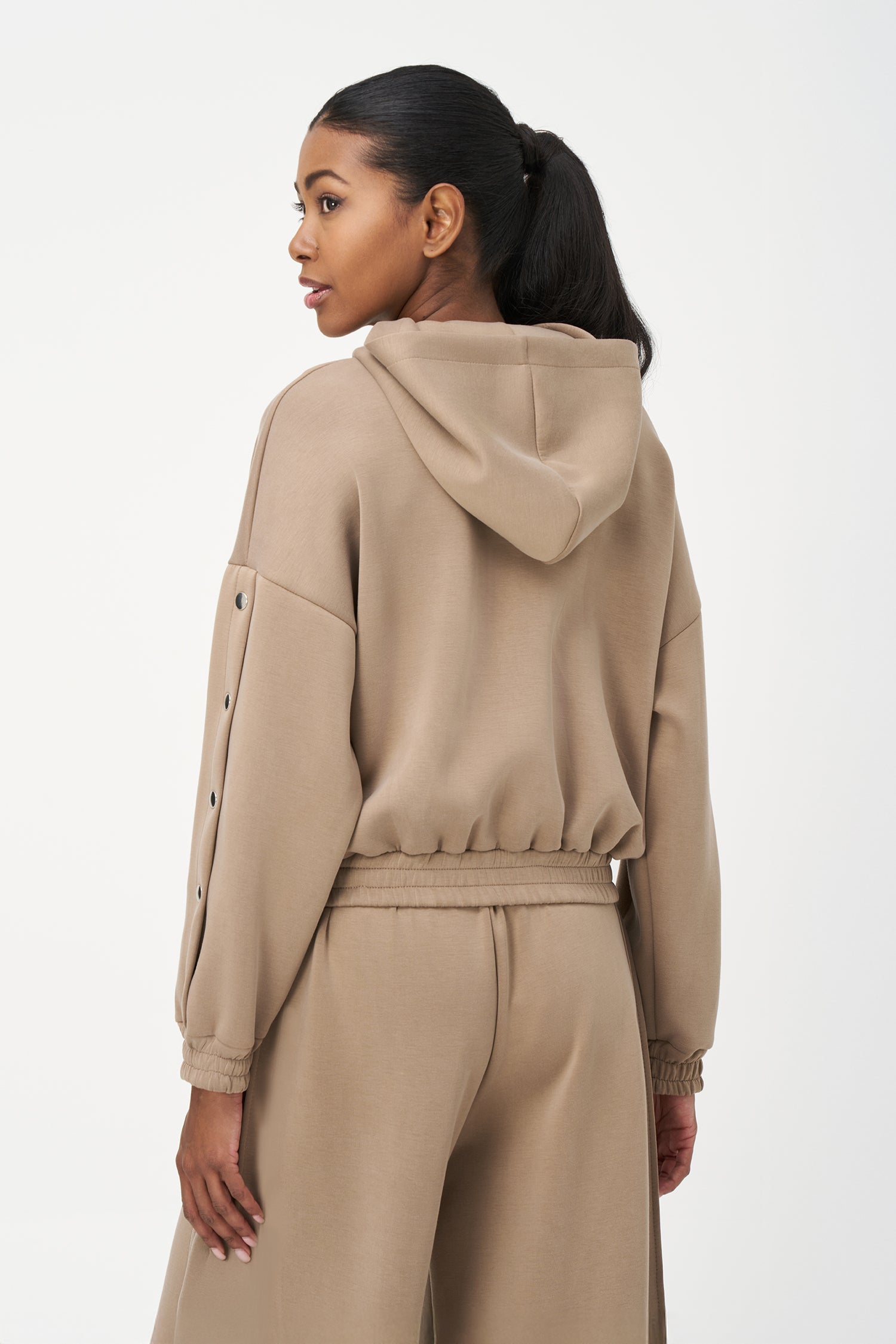 Beige zip-up hoodie with snap button sleeves and elastic cuffs and hem