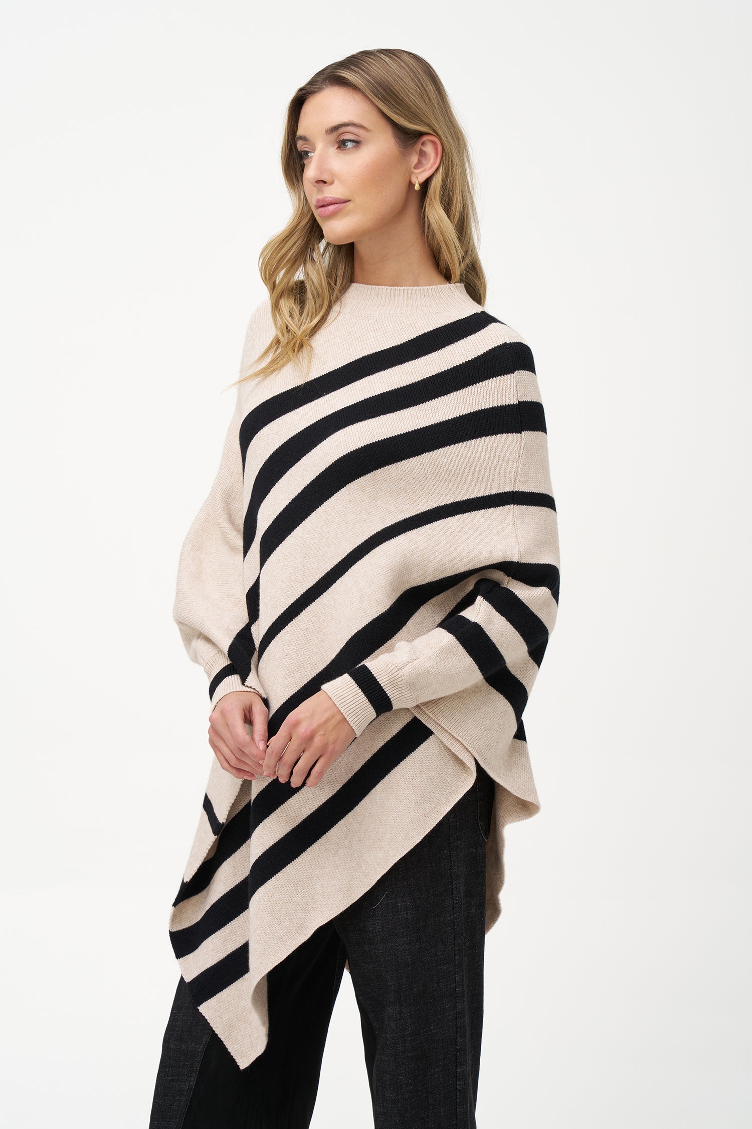 White asymmetrical poncho with beige diagonal stripes and ribbed neckline