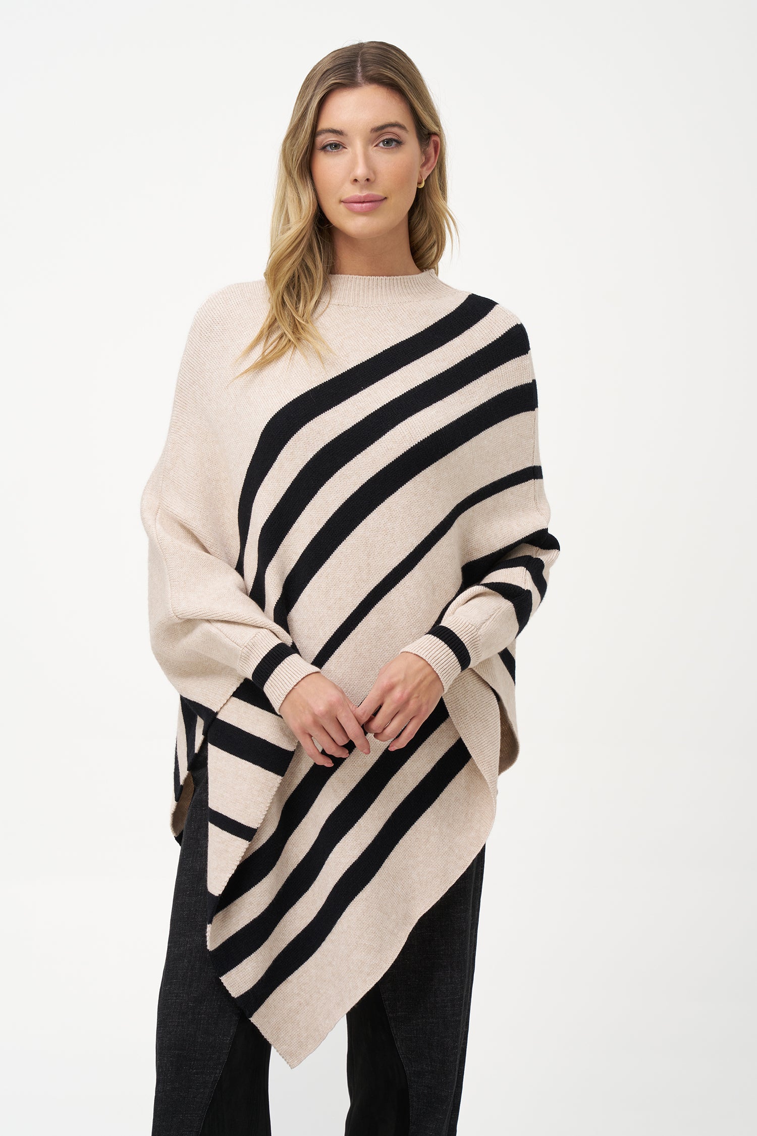 White asymmetrical poncho with beige diagonal stripes and ribbed neckline