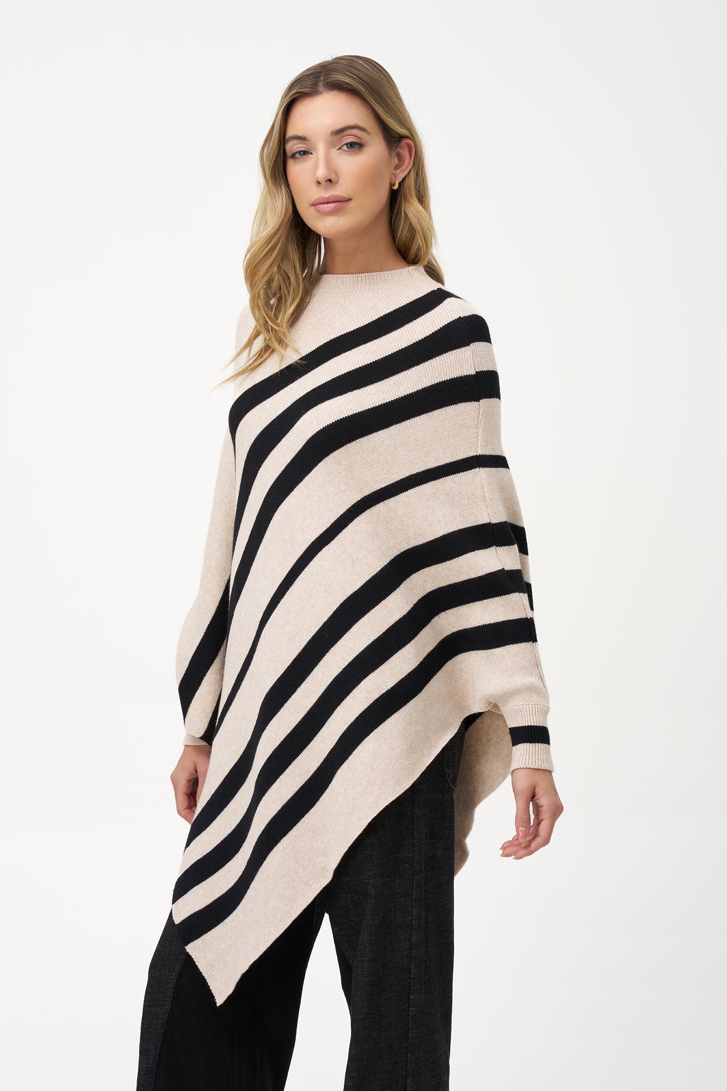 White asymmetrical poncho with beige diagonal stripes and ribbed neckline