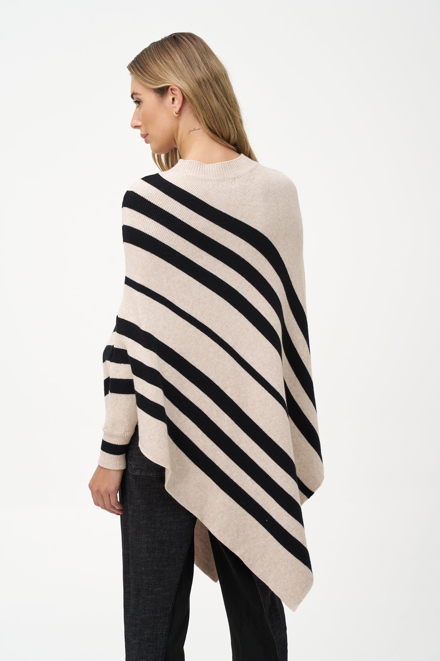 White asymmetrical poncho with beige diagonal stripes and ribbed neckline
