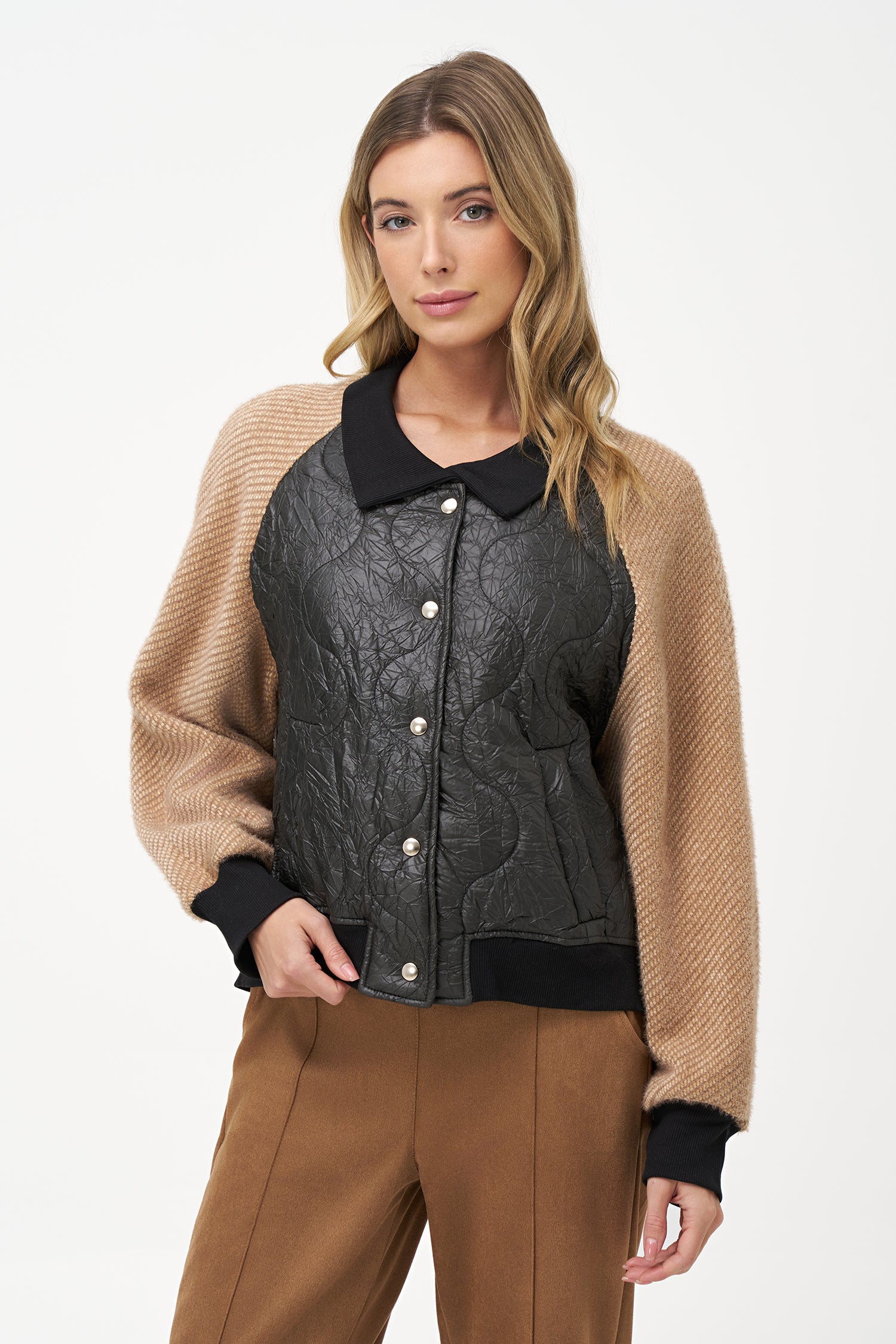 Two-tone bomber jacket with black crinkled quilted body and biscotti ribbed knit sleeves, front snap buttons, and contrast collar