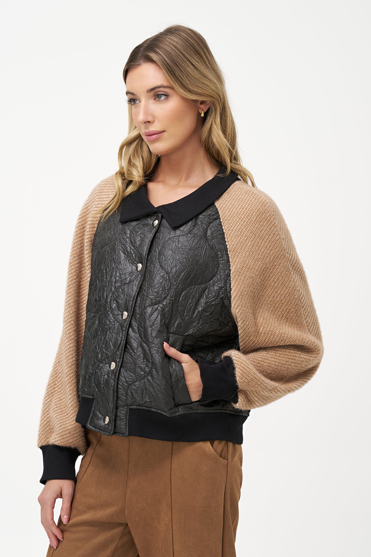 Two-tone bomber jacket with black crinkled quilted body and biscotti ribbed knit sleeves, front snap buttons, and contrast collar