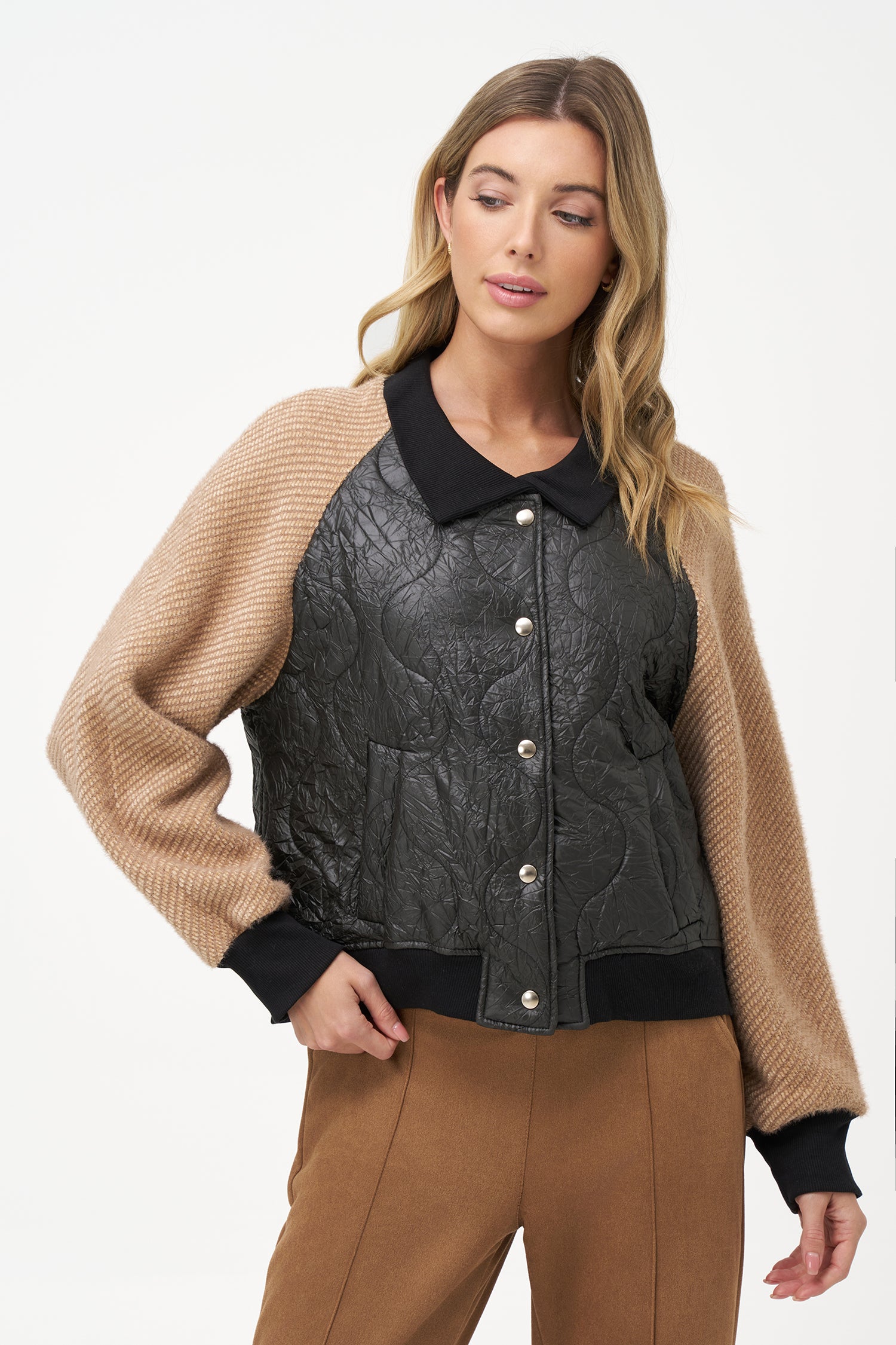Two-tone bomber jacket with black crinkled quilted body and biscotti ribbed knit sleeves, front snap buttons, and contrast collar