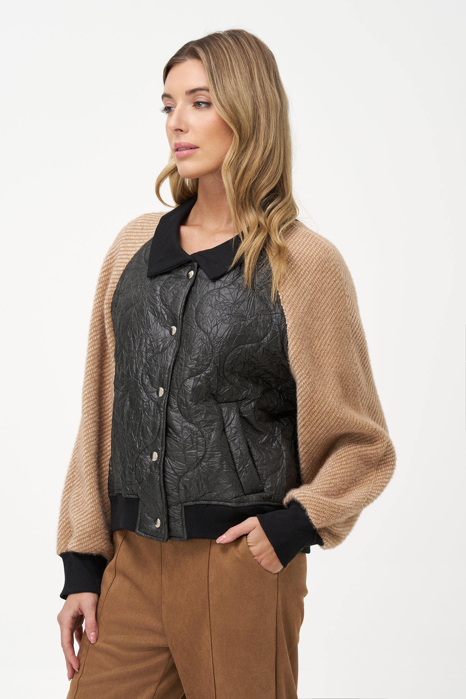 Two-tone bomber jacket with black crinkled quilted body and biscotti ribbed knit sleeves, front snap buttons, and contrast collar