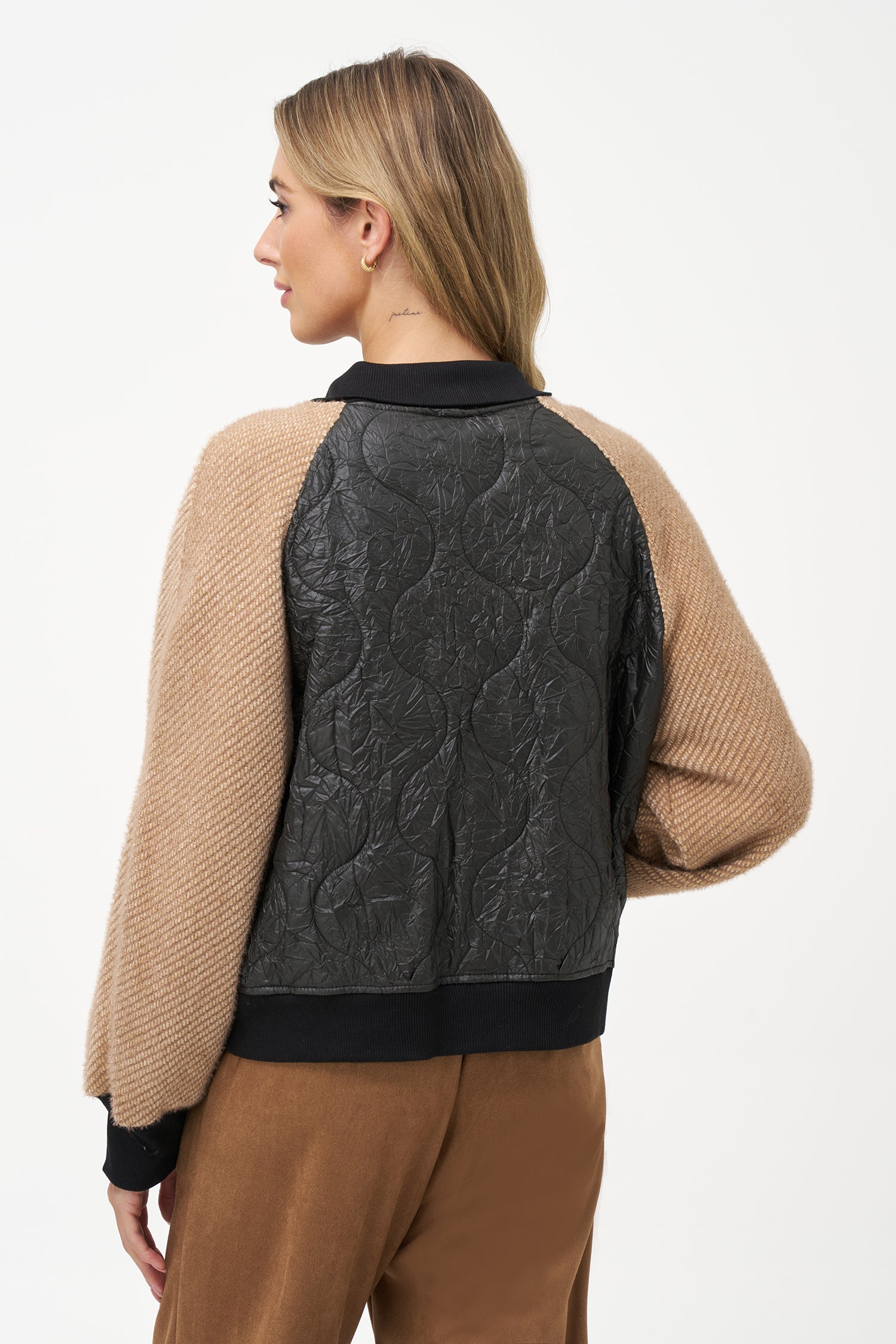 Two-tone bomber jacket with black crinkled quilted body and biscotti ribbed knit sleeves, front snap buttons, and contrast collar