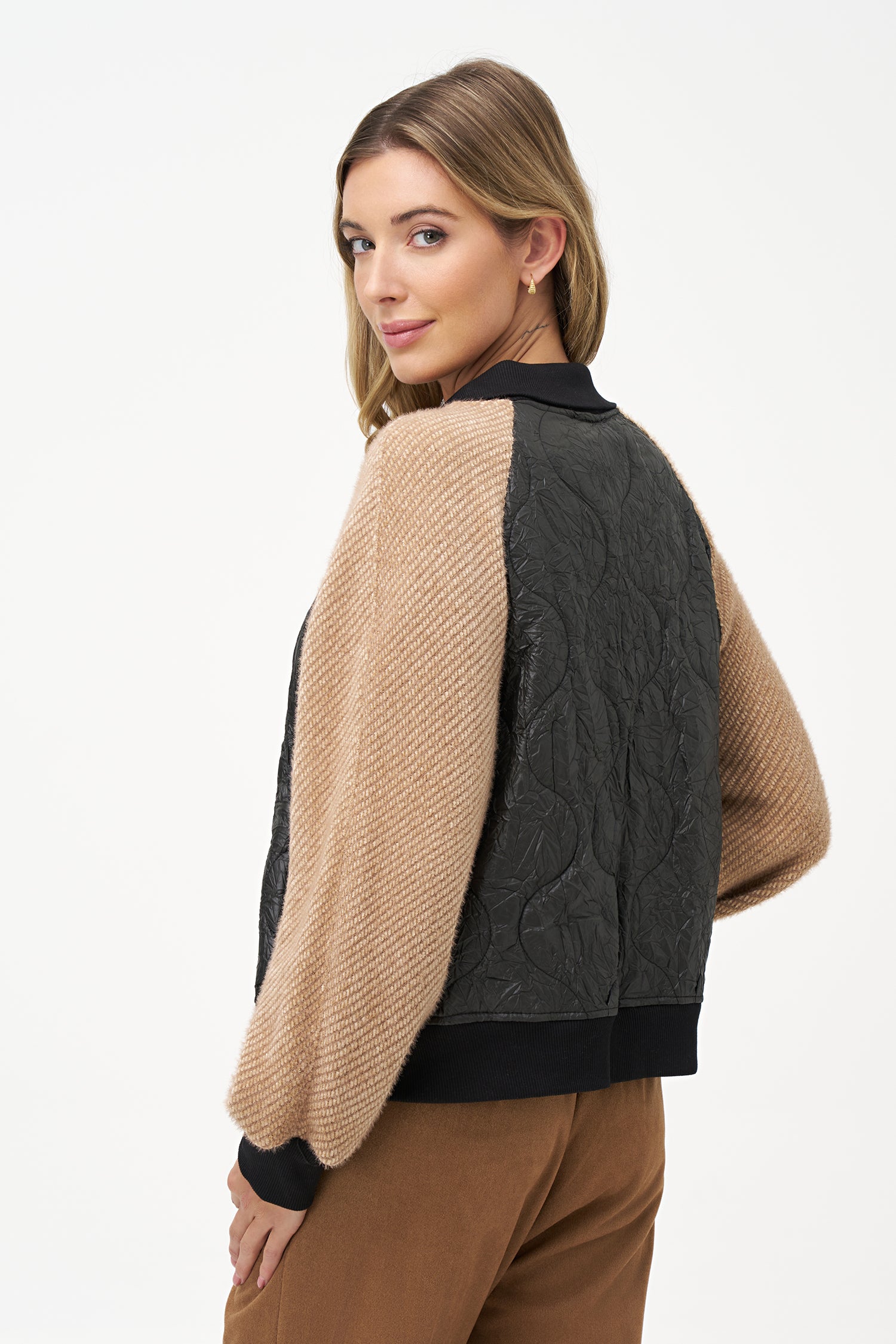 Two-tone bomber jacket with black crinkled quilted body and biscotti ribbed knit sleeves, front snap buttons, and contrast collar
