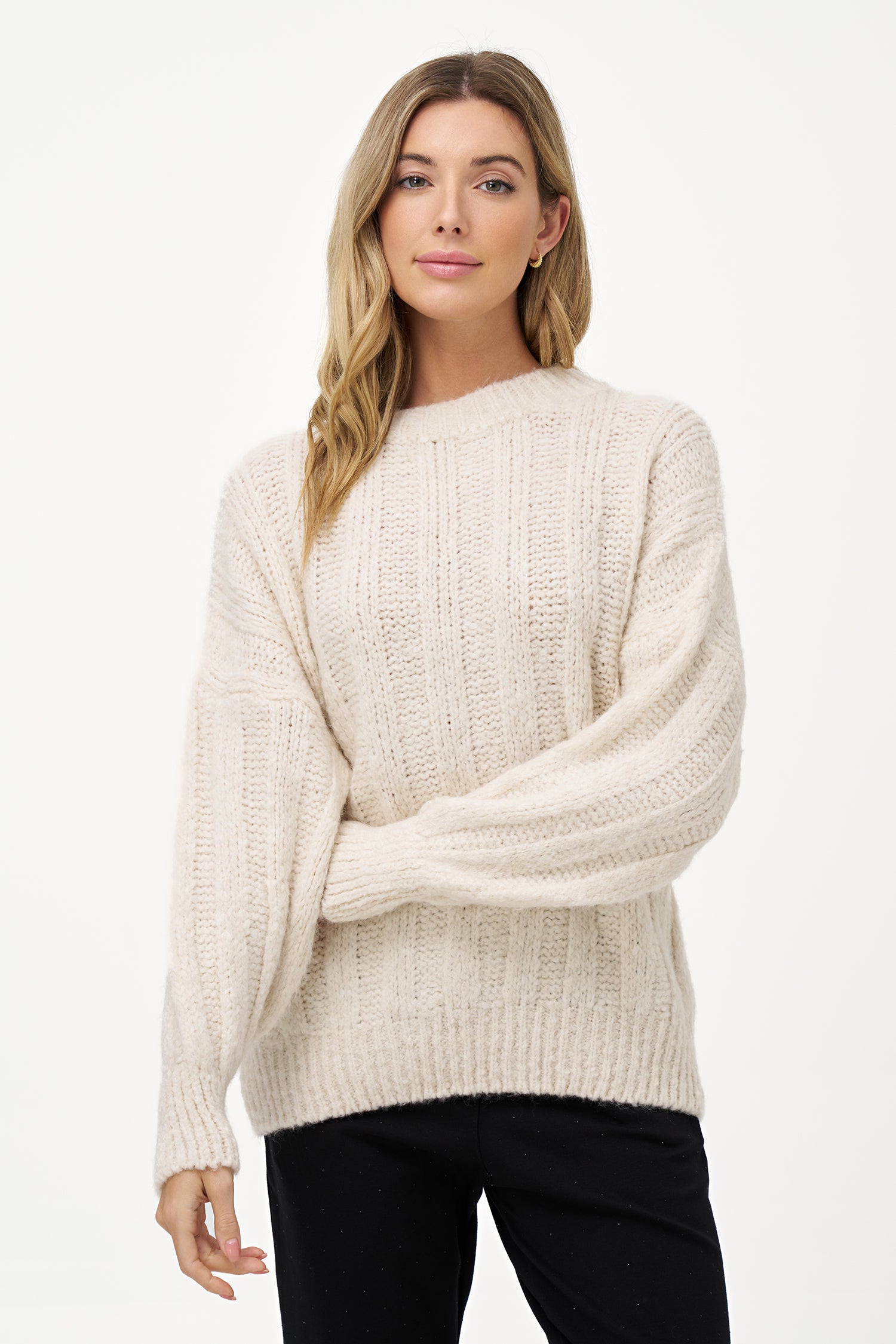 White knit women's sweater with ribbed texture, long sleeves, and wool blend fabric for cozy winter layering.