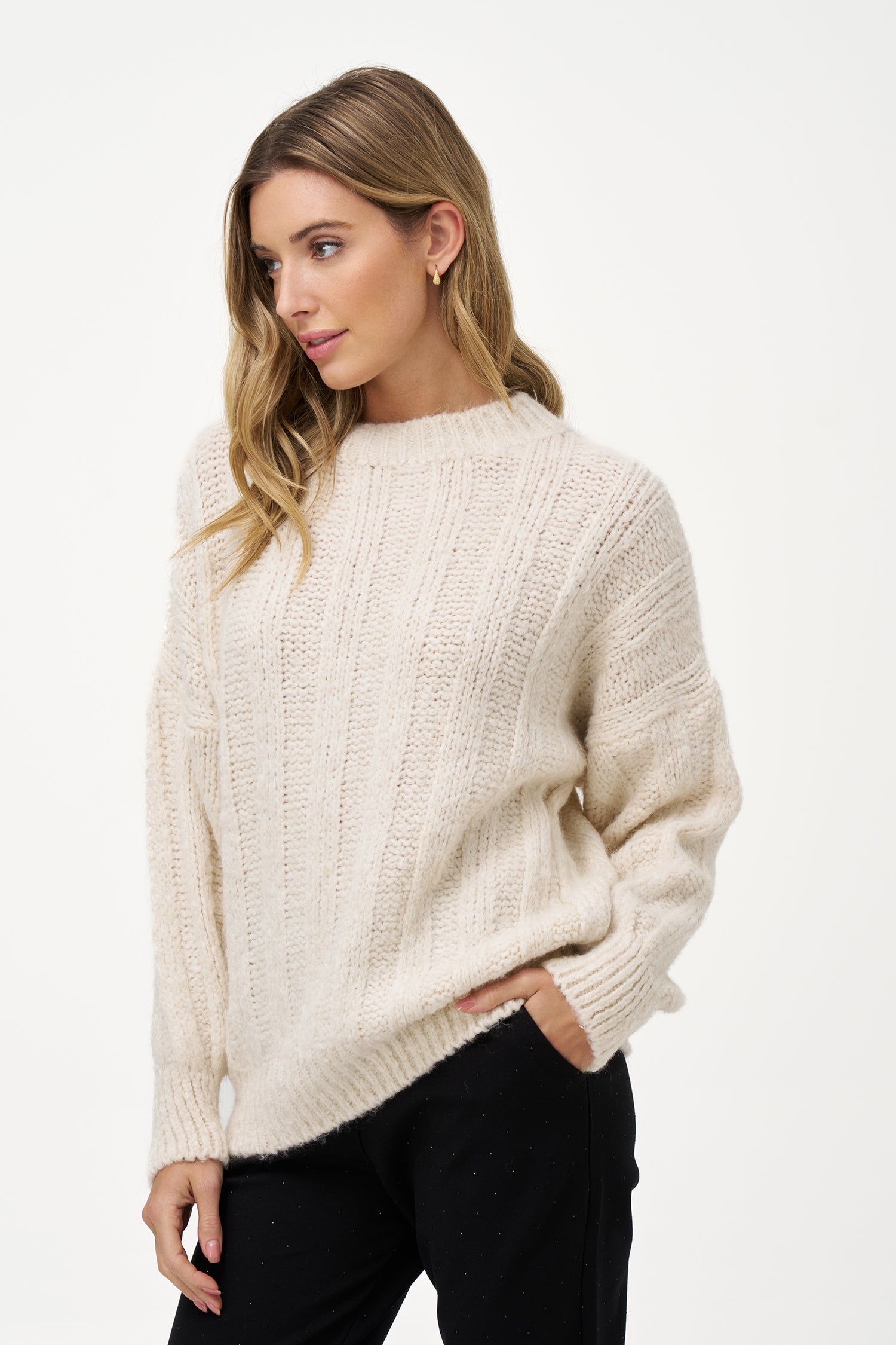 White knit women's sweater with ribbed texture, long sleeves, and wool blend fabric for cozy winter layering.