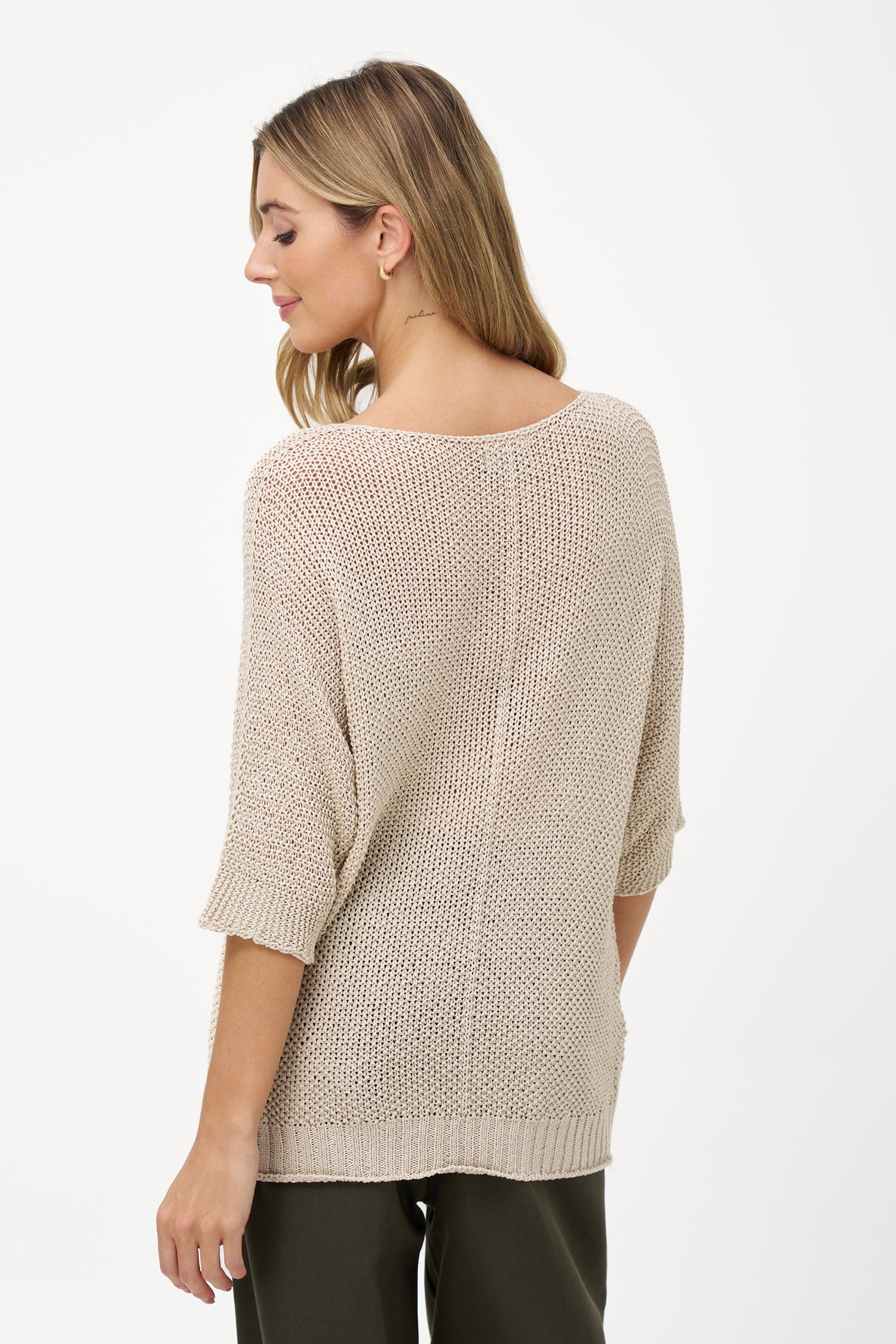 White acrylic knit sweater with elbow-length sleeves, scoop neckline, and textured semi-sheer finish for a relaxed, breathable look.