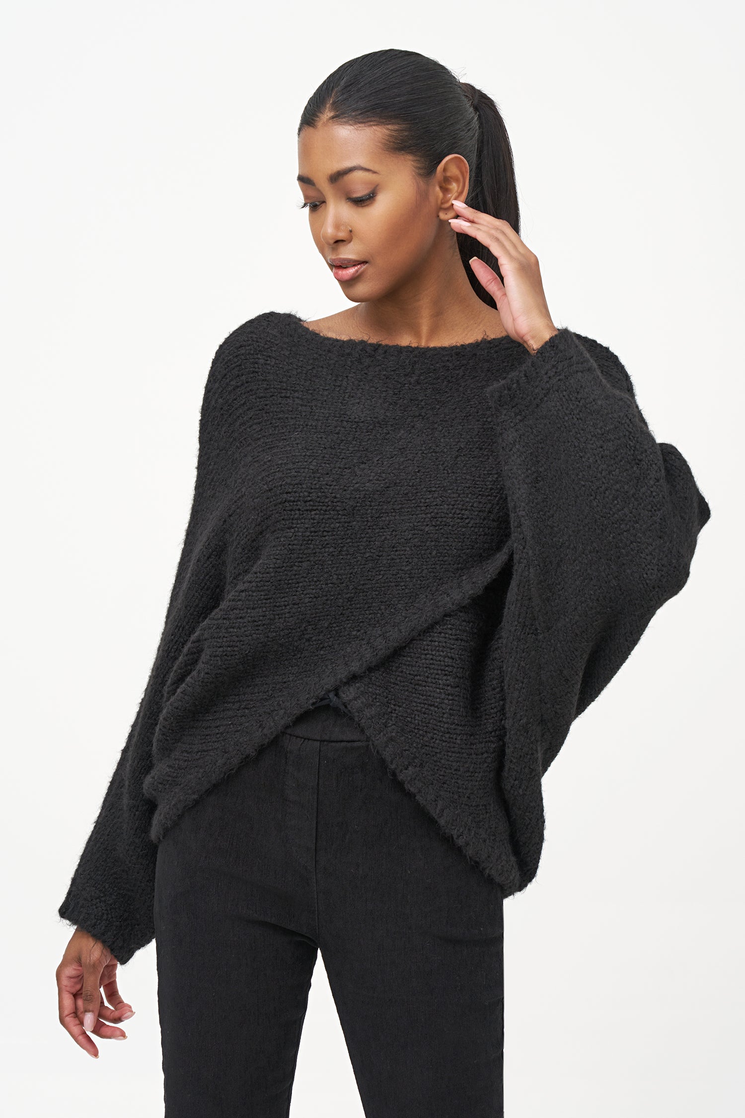 Black acrylic-blend sweater with a soft textured knit, long sleeves, and diagonal front overlay for a relaxed, stylish silhouette.