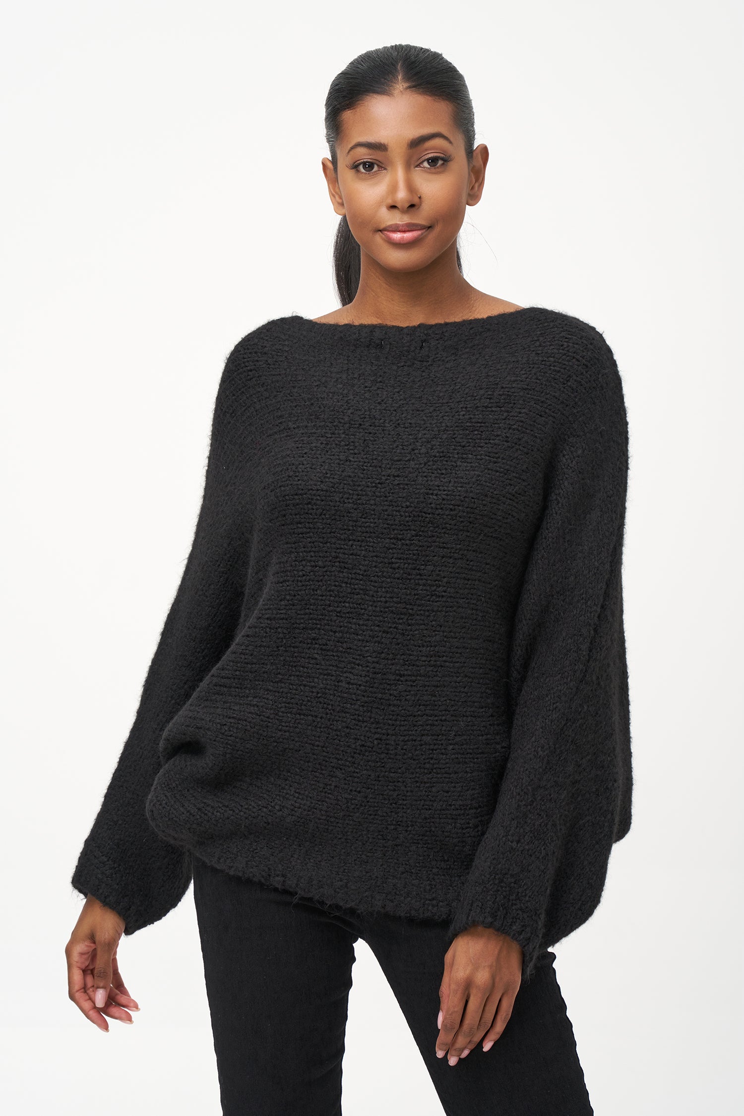Black acrylic-blend sweater with a soft textured knit, long sleeves, and diagonal front overlay for a relaxed, stylish silhouette.