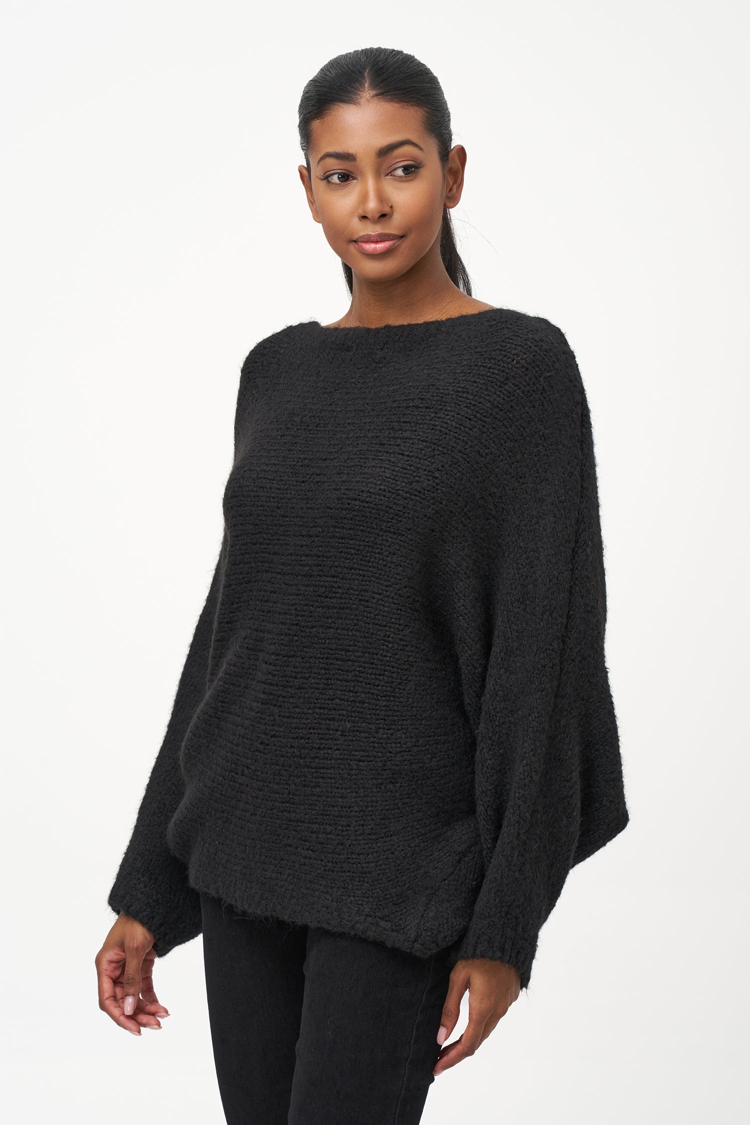Black acrylic-blend sweater with a soft textured knit, long sleeves, and diagonal front overlay for a relaxed, stylish silhouette.