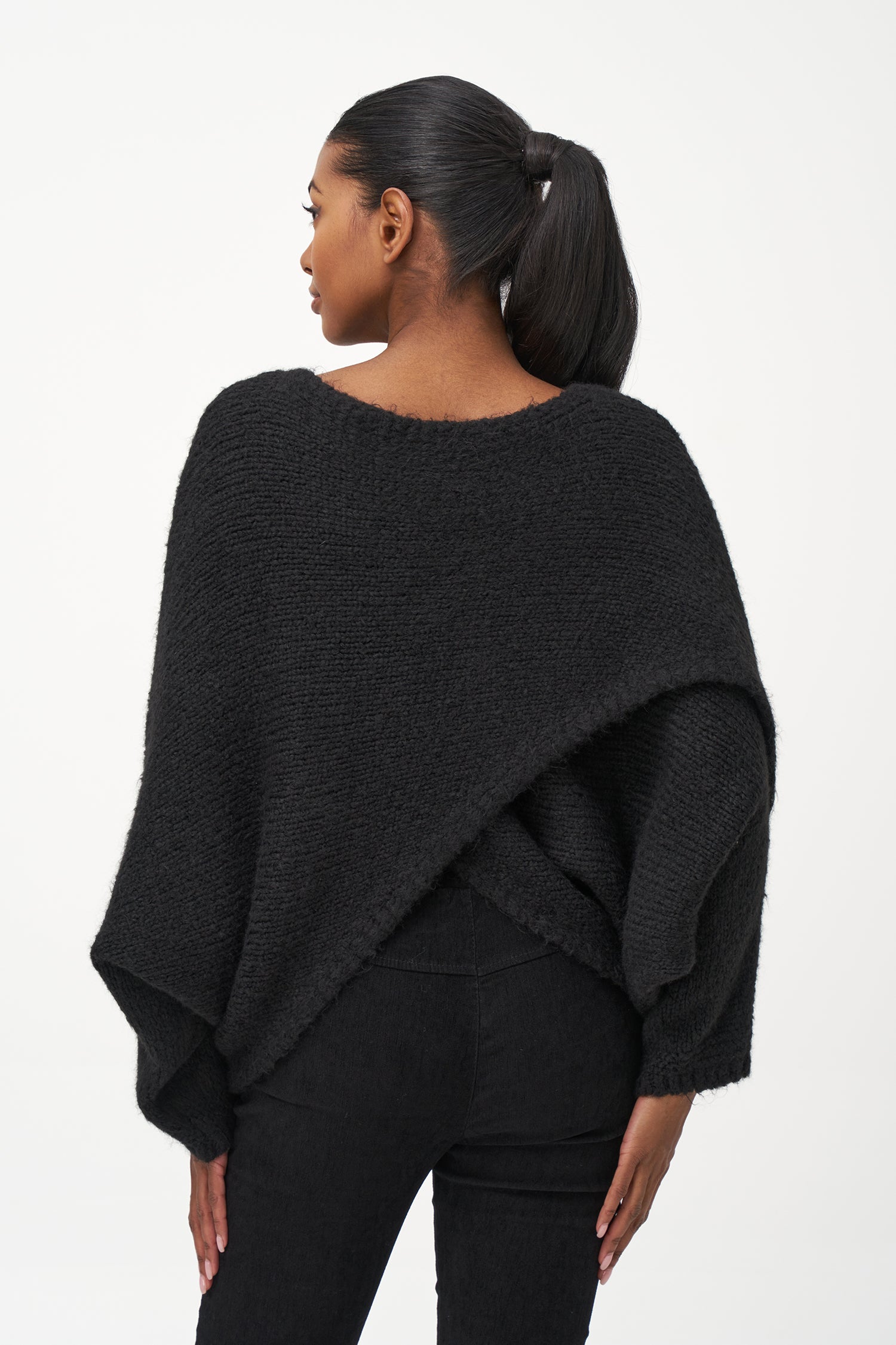 Black acrylic-blend sweater with a soft textured knit, long sleeves, and diagonal front overlay for a relaxed, stylish silhouette.