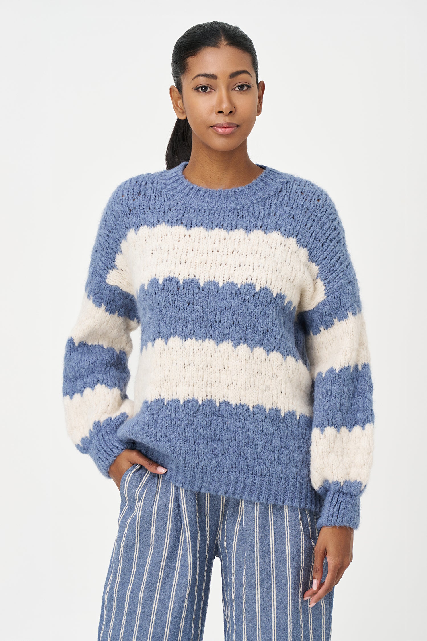 Green-Blue and White striped sweater in soft acrylic blend with a fuzzy texture and relaxed fit, perfect for layering on chilly days.