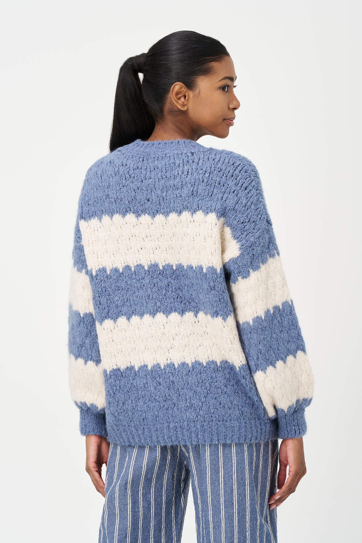 Green-Blue and White striped sweater in soft acrylic blend with a fuzzy texture and relaxed fit, perfect for layering on chilly days.