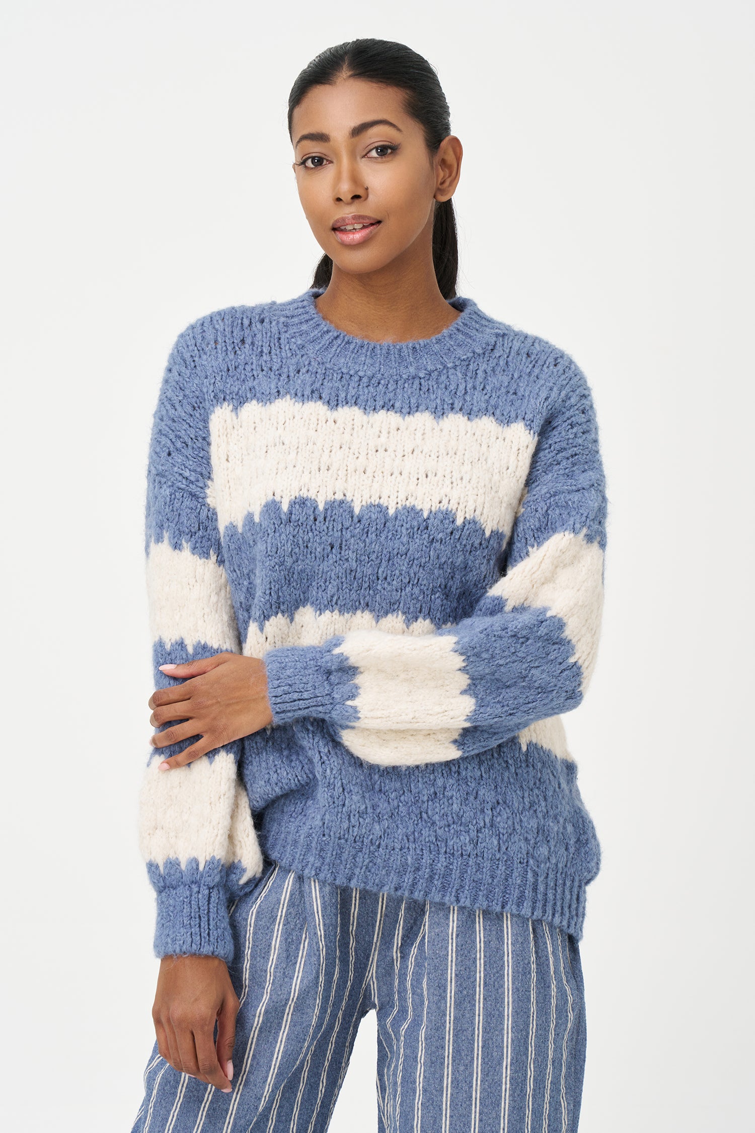 Green-Blue and White striped sweater in soft acrylic blend with a fuzzy texture and relaxed fit, perfect for layering on chilly days.
