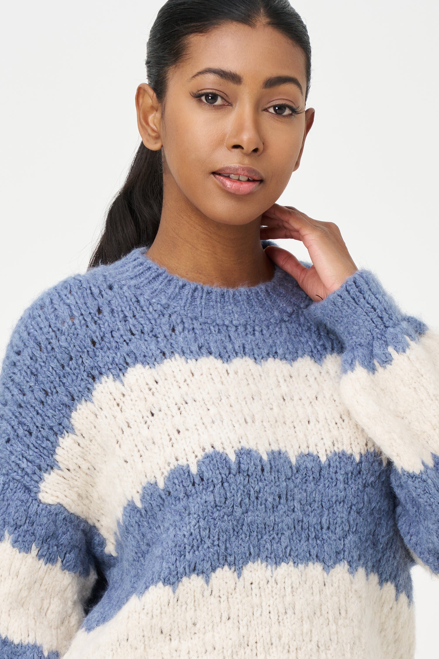 Green-Blue and White striped sweater in soft acrylic blend with a fuzzy texture and relaxed fit, perfect for layering on chilly days.