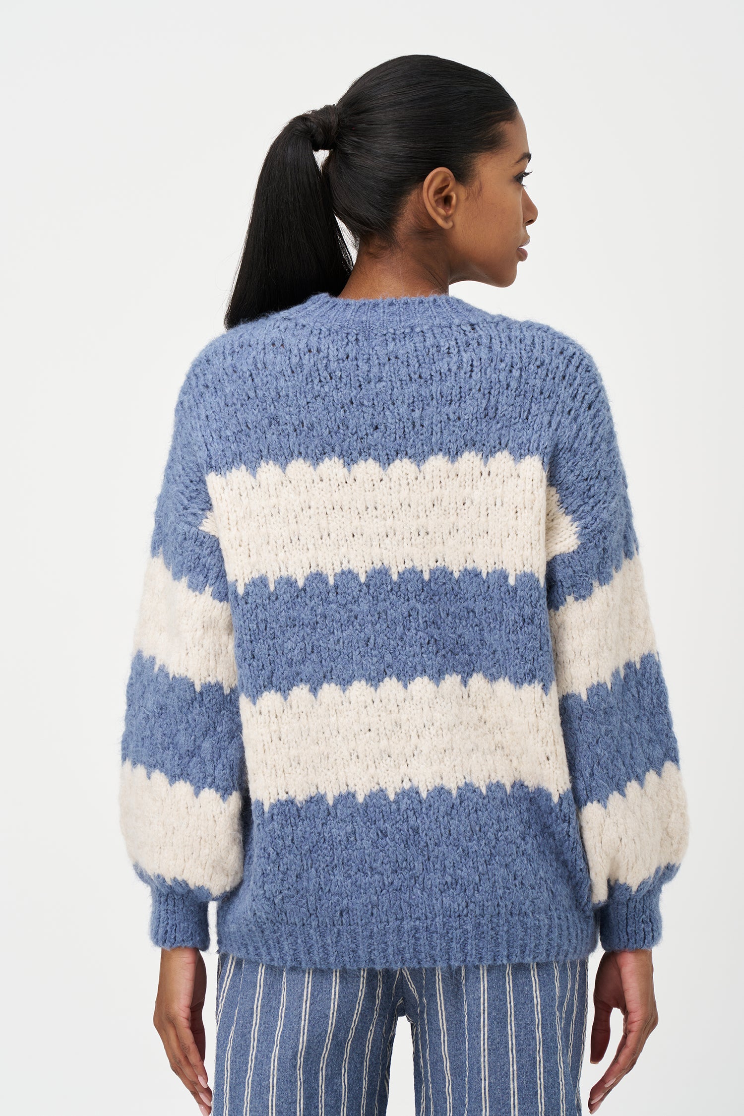 Green-Blue and White striped sweater in soft acrylic blend with a fuzzy texture and relaxed fit, perfect for layering on chilly days.